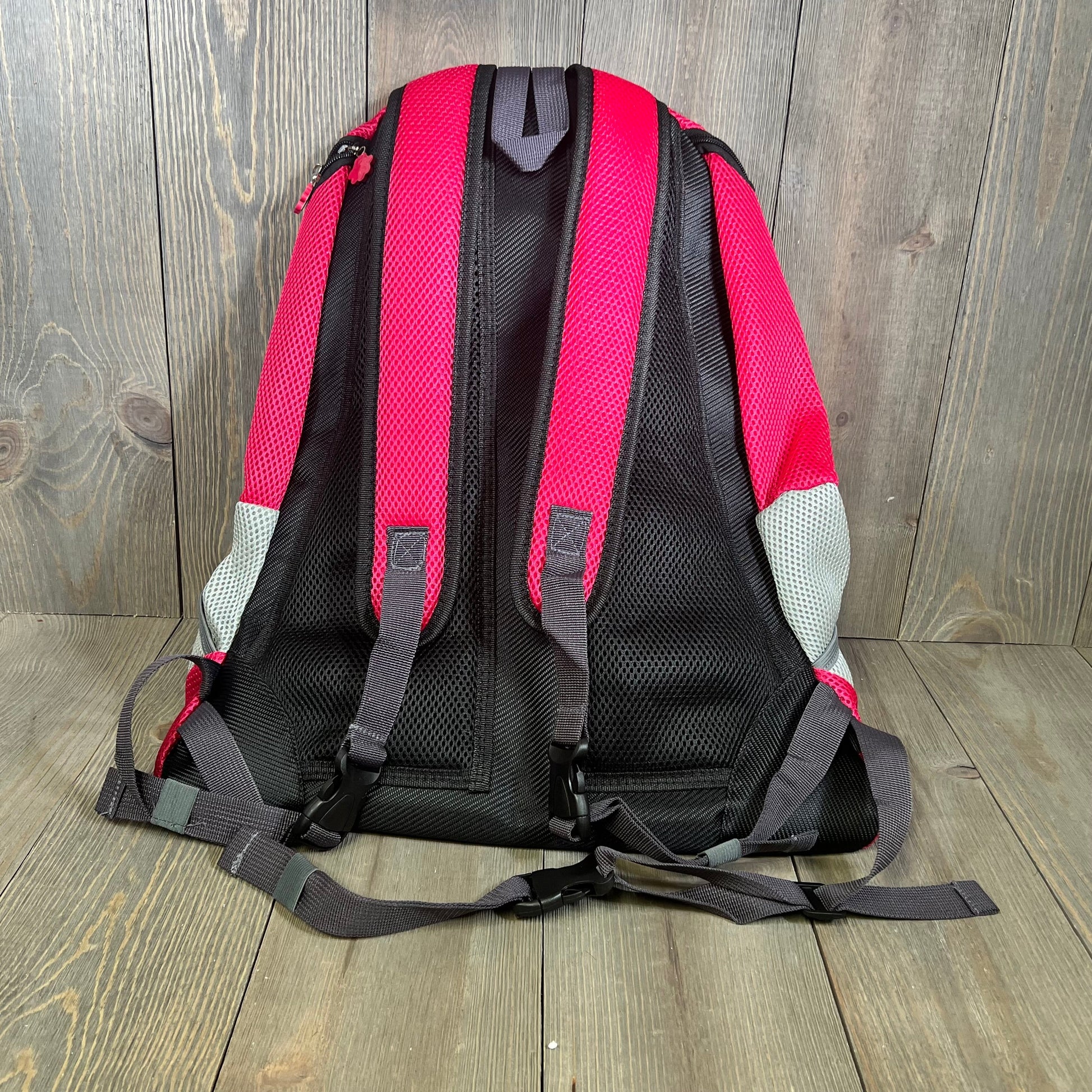 Pink wuffie pet carrier backpack, adjustable straps shown, breathable Oxford fabric, ideal for medium to large dogs.