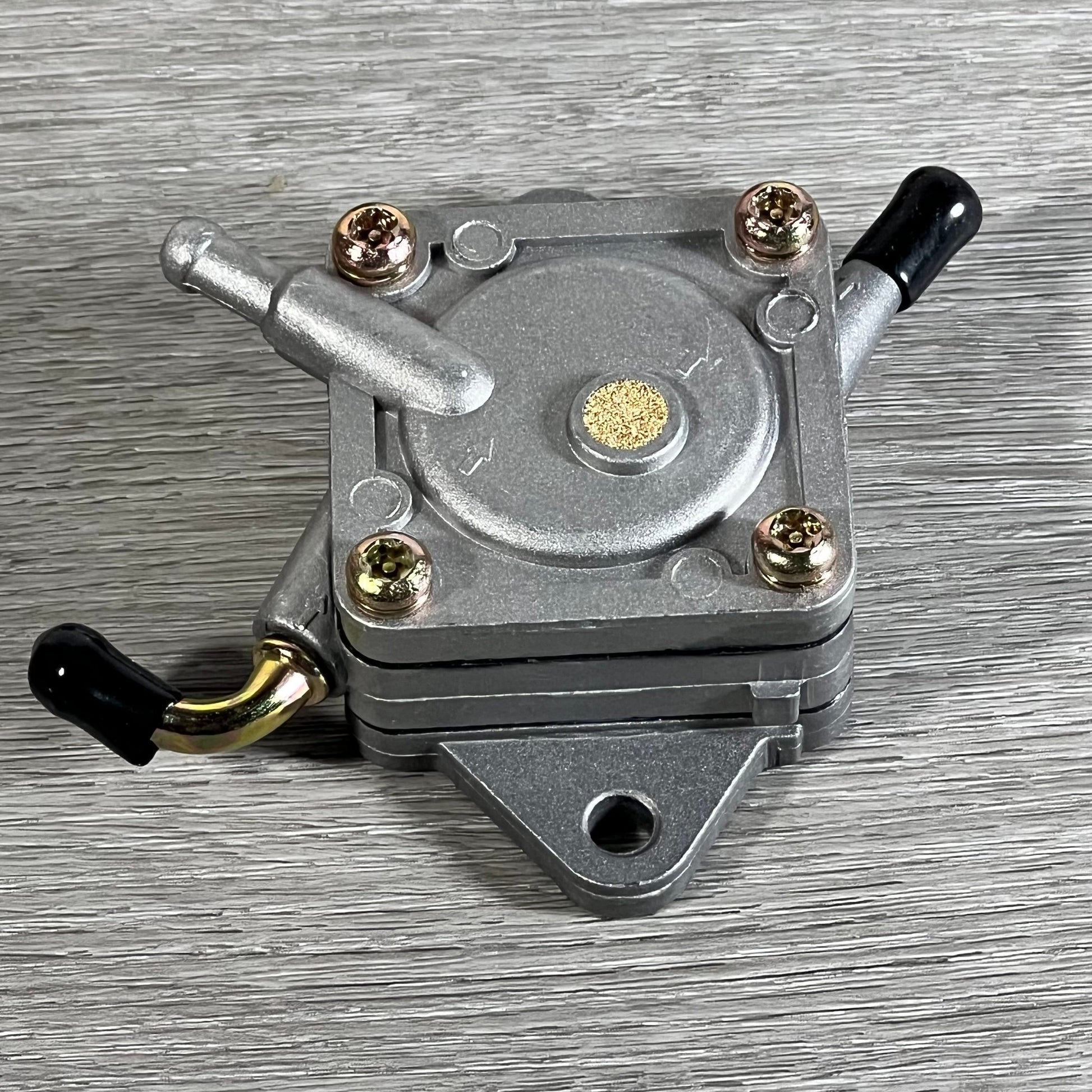 Durable Cylinman carburetor for John Deere mowers, featuring robust metal construction on a wooden background.