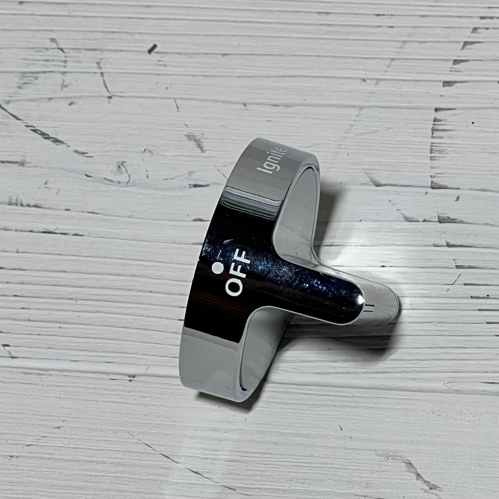 Durable stainless steel gas stove knob replacement for Whirlpool, showing 'OFF' position on a textured surface.