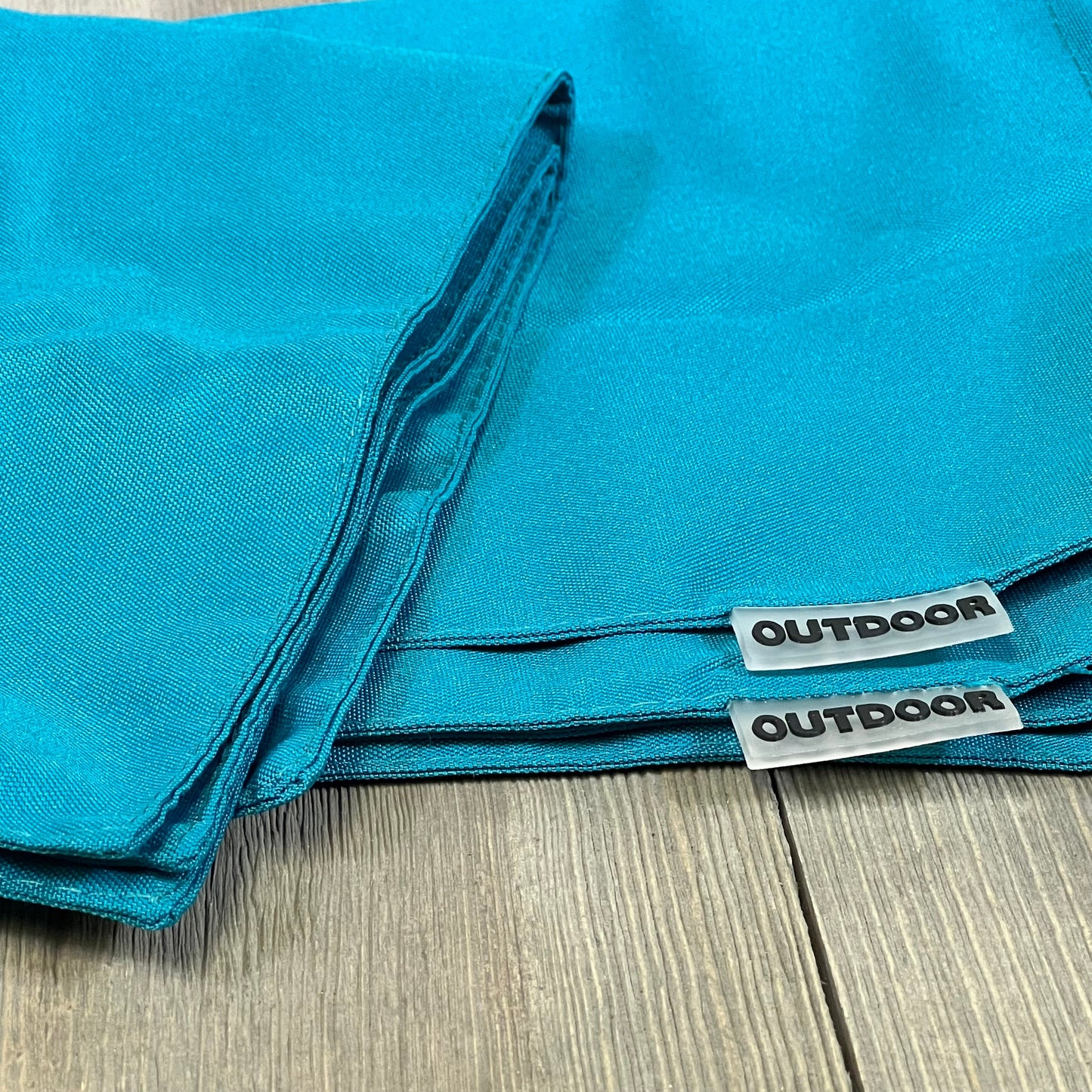 Teal blue waterproof pillow covers for outdoor use, featuring durable material and labeled "outdoor" for garden decor.