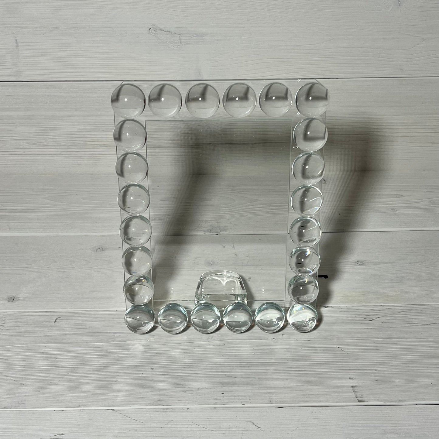 Elegant 5x7 crystal photo frame with 24 clear bubble accents, perfect for a sophisticated office or home display.