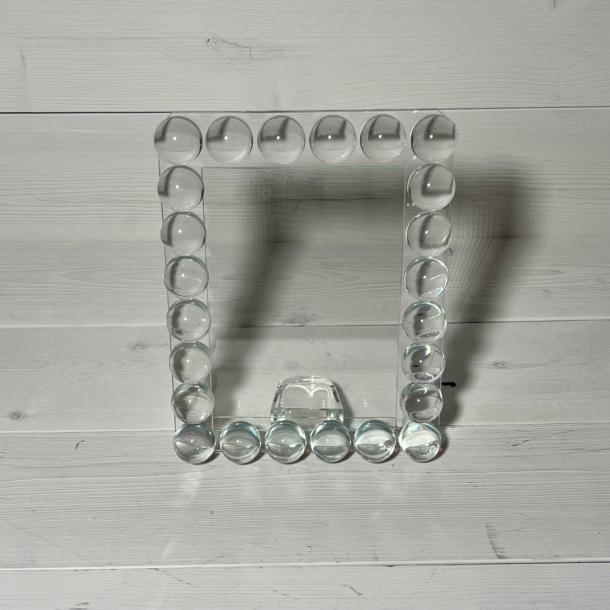 Elegant 5x7 crystal photo frame with 24 clear bubble accents, perfect for a sophisticated office or home display.