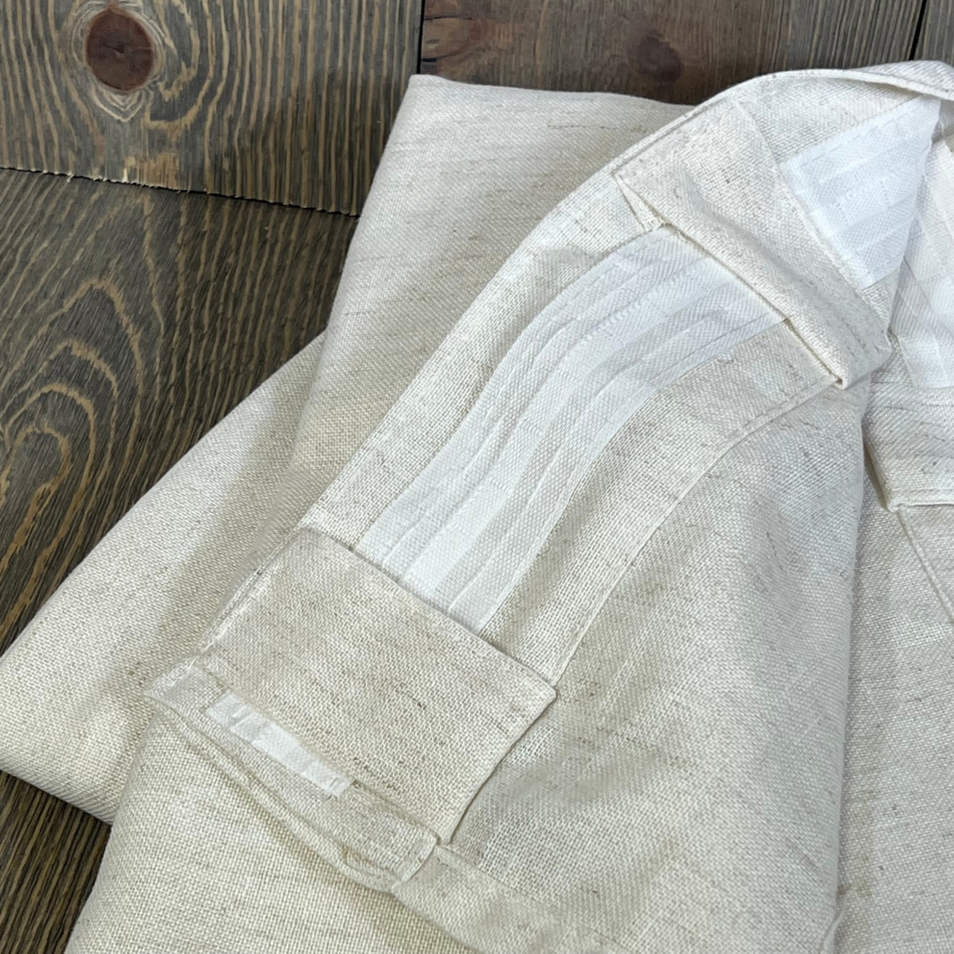 Cream beige linen sheer curtains with back tab hooks, showcasing texture and pleat detail for elegant window decor.