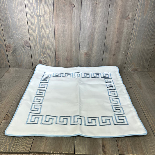 Baby blue embroidered Greek key pillow cover on wooden surface, showcasing premium quality and water-repellent fabric.