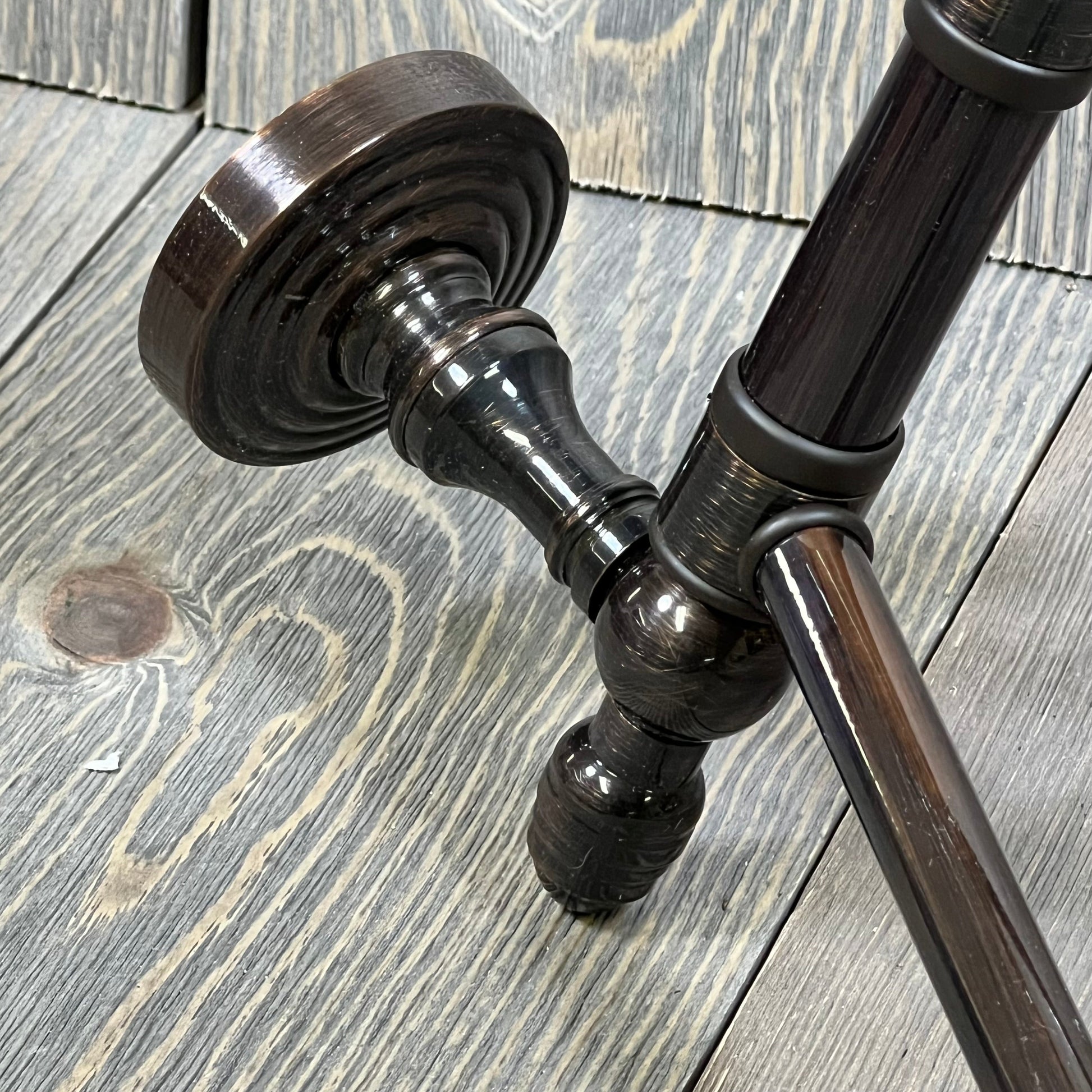 Antique copper swing arm towel rail from Allied Brass Waverly Place Collection on rustic wooden surface.