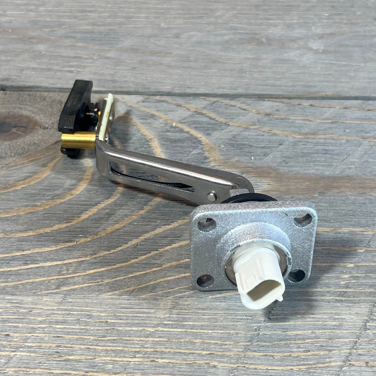 Engine oil level sensor for Lexus GS430 2006-2007, LS430 2001-2006 on wooden background. Part# 89491-50030.