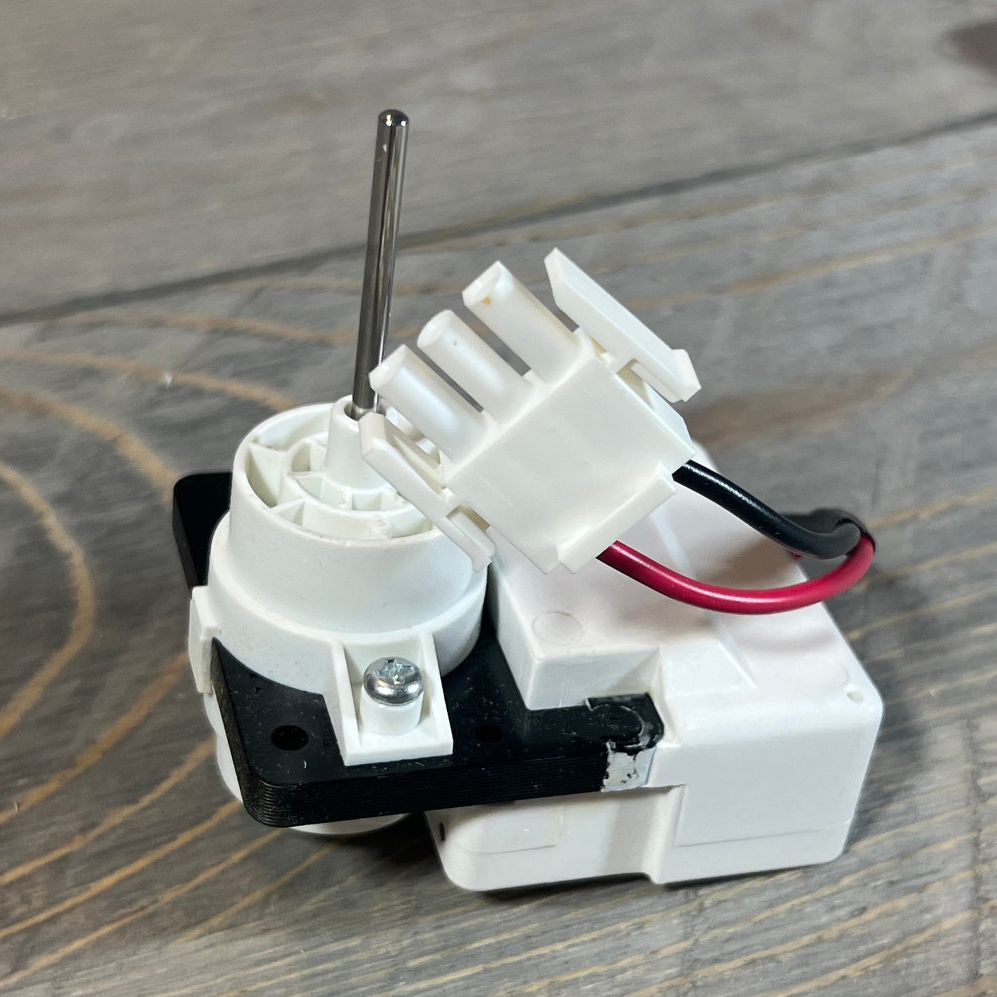 Evaporator fan motor for Frigidaire and Kenmore refrigerators, featuring durable construction and wiring connections.