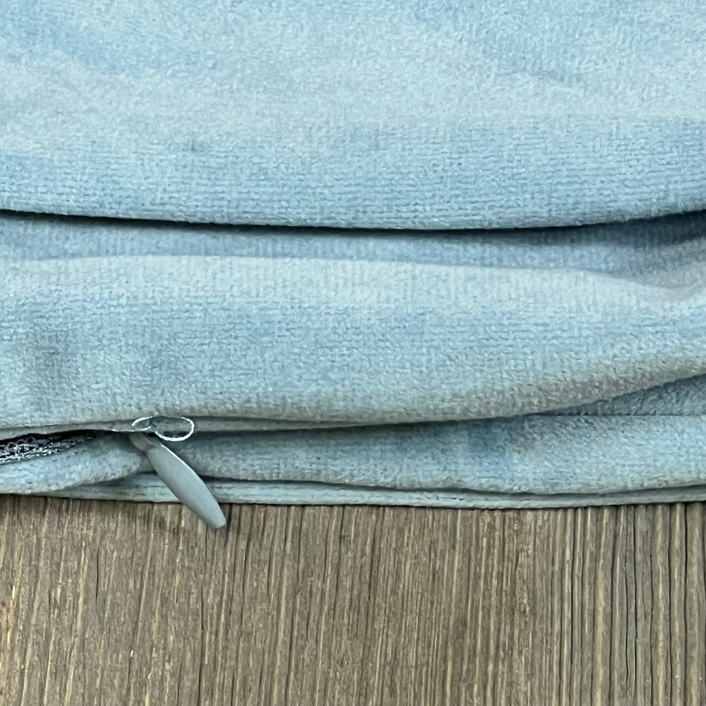 Silver blue velvet cushion covers with zipper detail, 20x20 inch, on wooden surface. Ideal for bed, couch, or sofa decor.