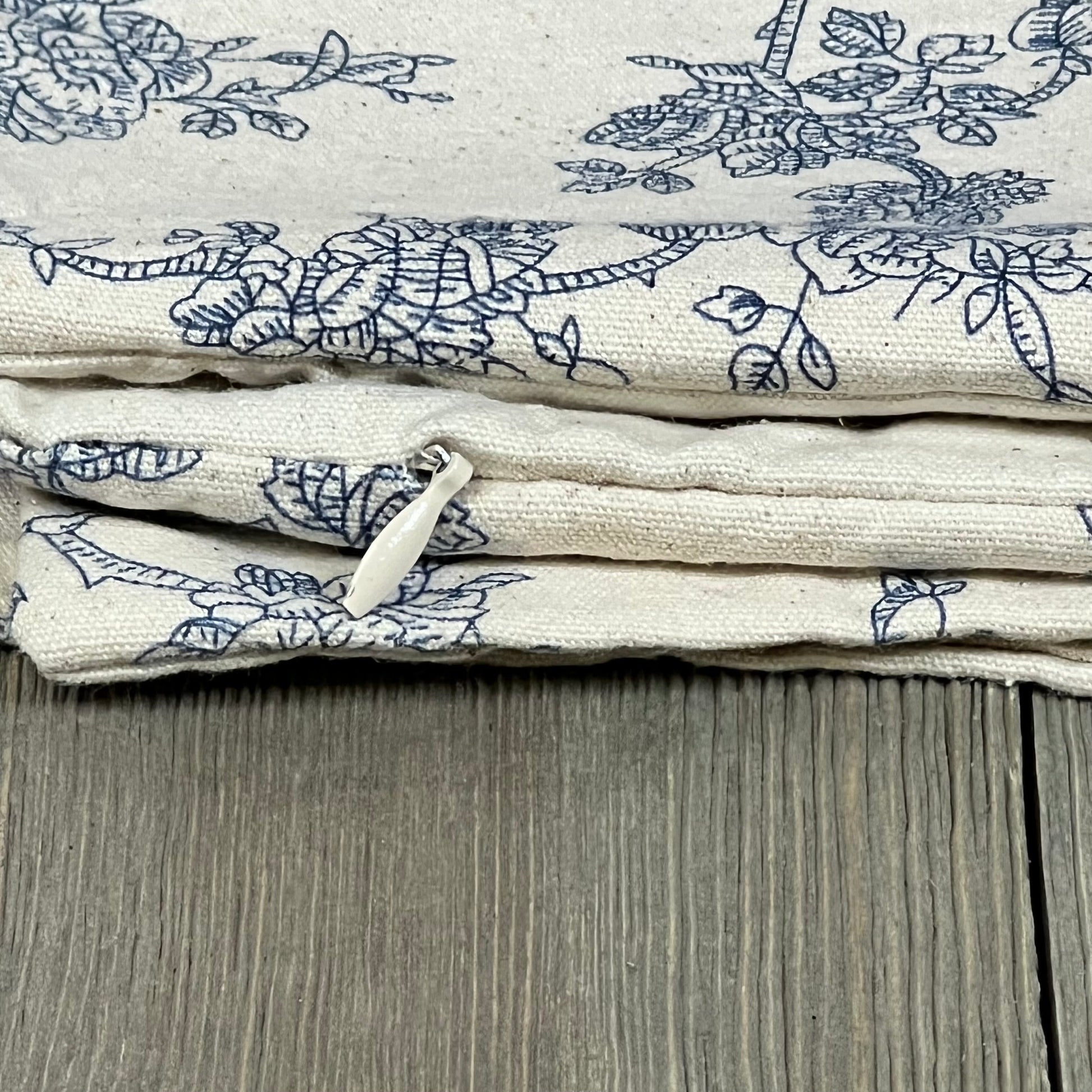Blue floral pattern on 100% cotton throw pillow covers, showcasing zipper detail for easy use; perfect for farmhouse decor.