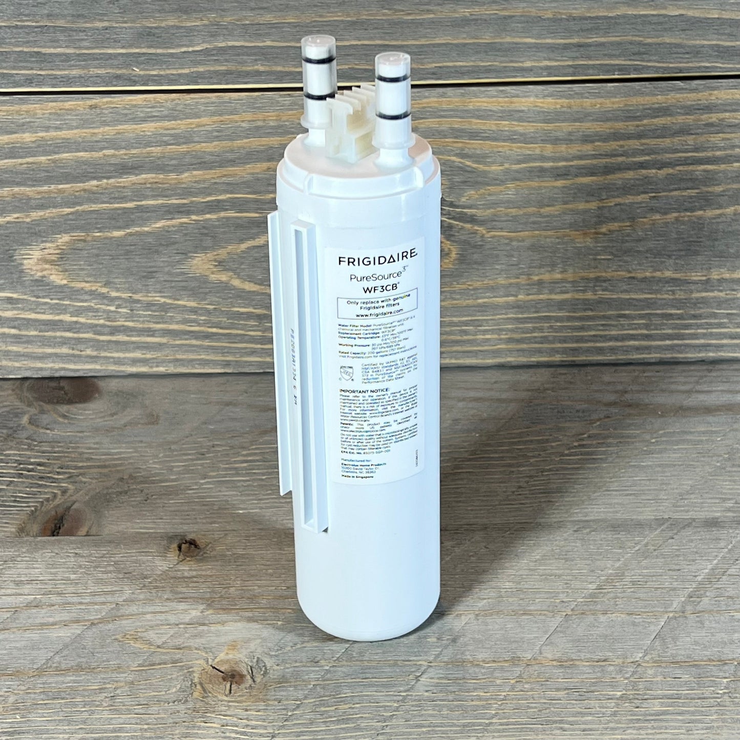 Frigidaire WF3CB PureSource3 water filter cartridge on wooden surface, showcasing dual connectors and detailed label.
