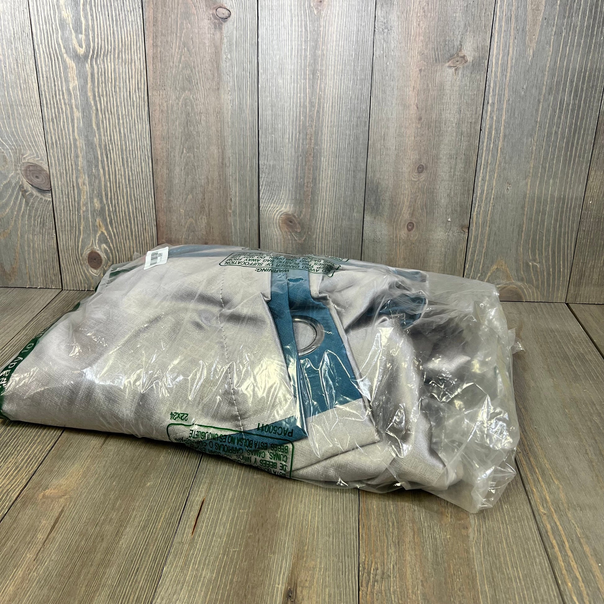 Blue and grey patchwork curtains packaged, showcasing the thermal insulated fabric, ideal for room darkening in bedrooms.