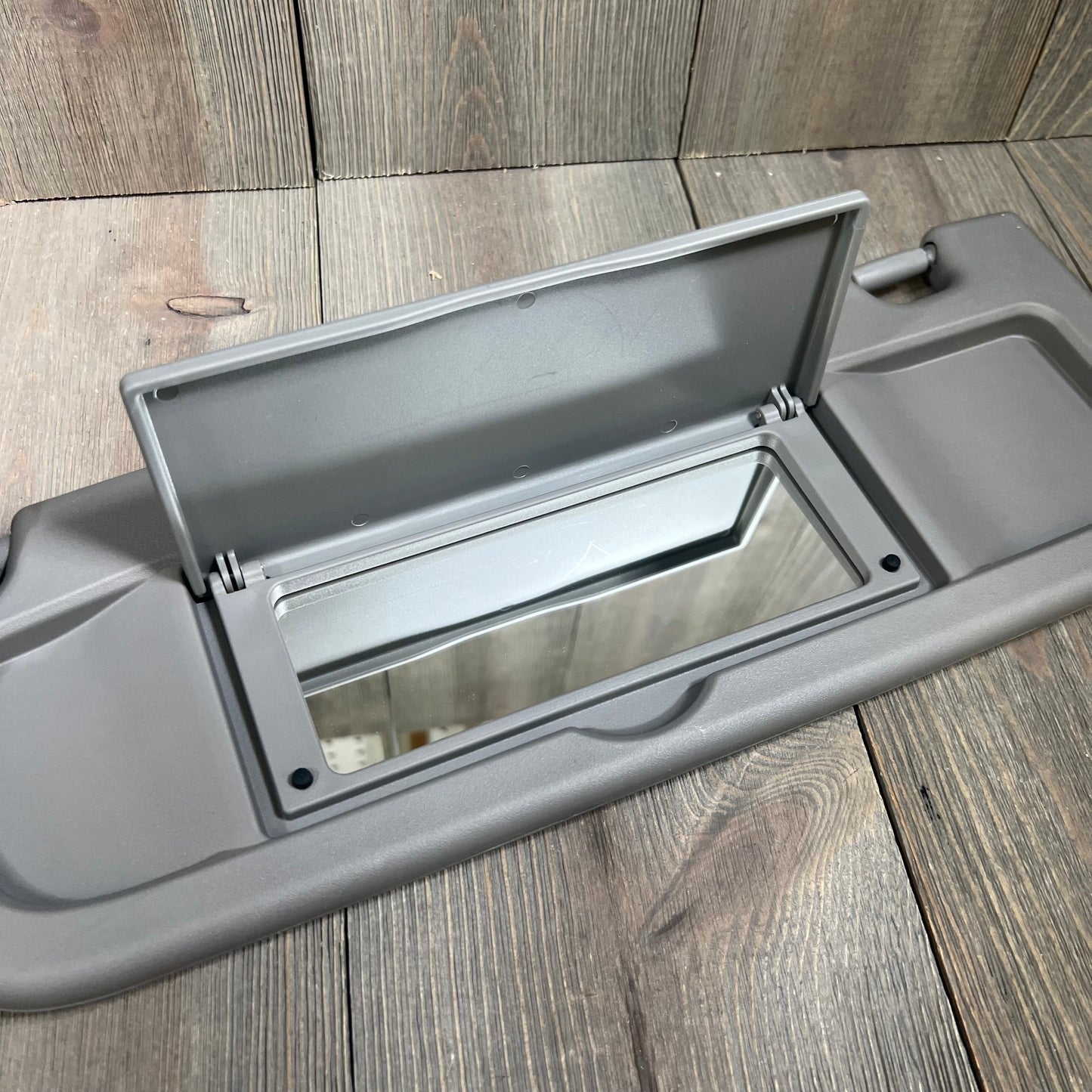 Gray Dorman 74439 driver side sun visor with mirror for select Honda models, offering a stylish and functional upgrade.
