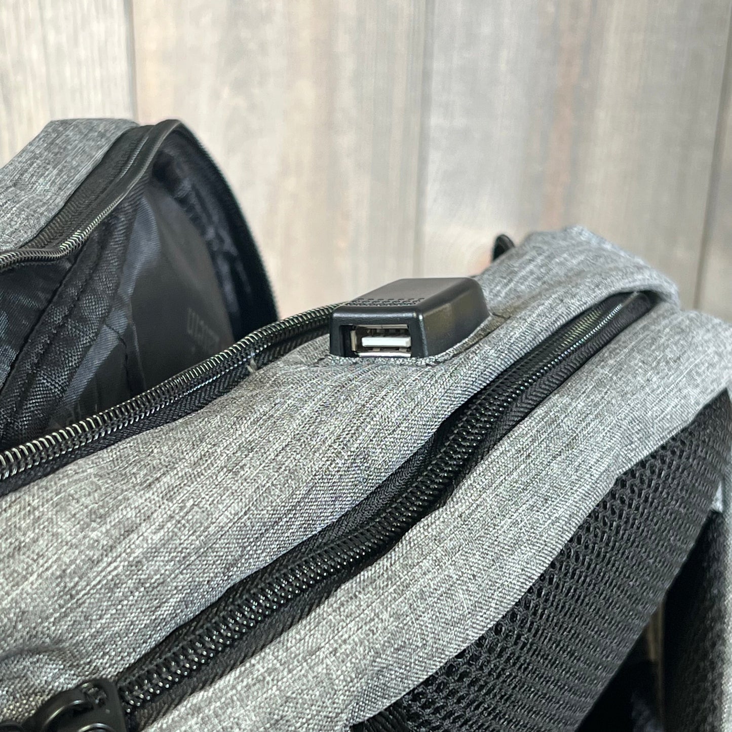 Grey MATEIN travel laptop backpack showcasing built-in USB charging port for convenient device charging on-the-go.