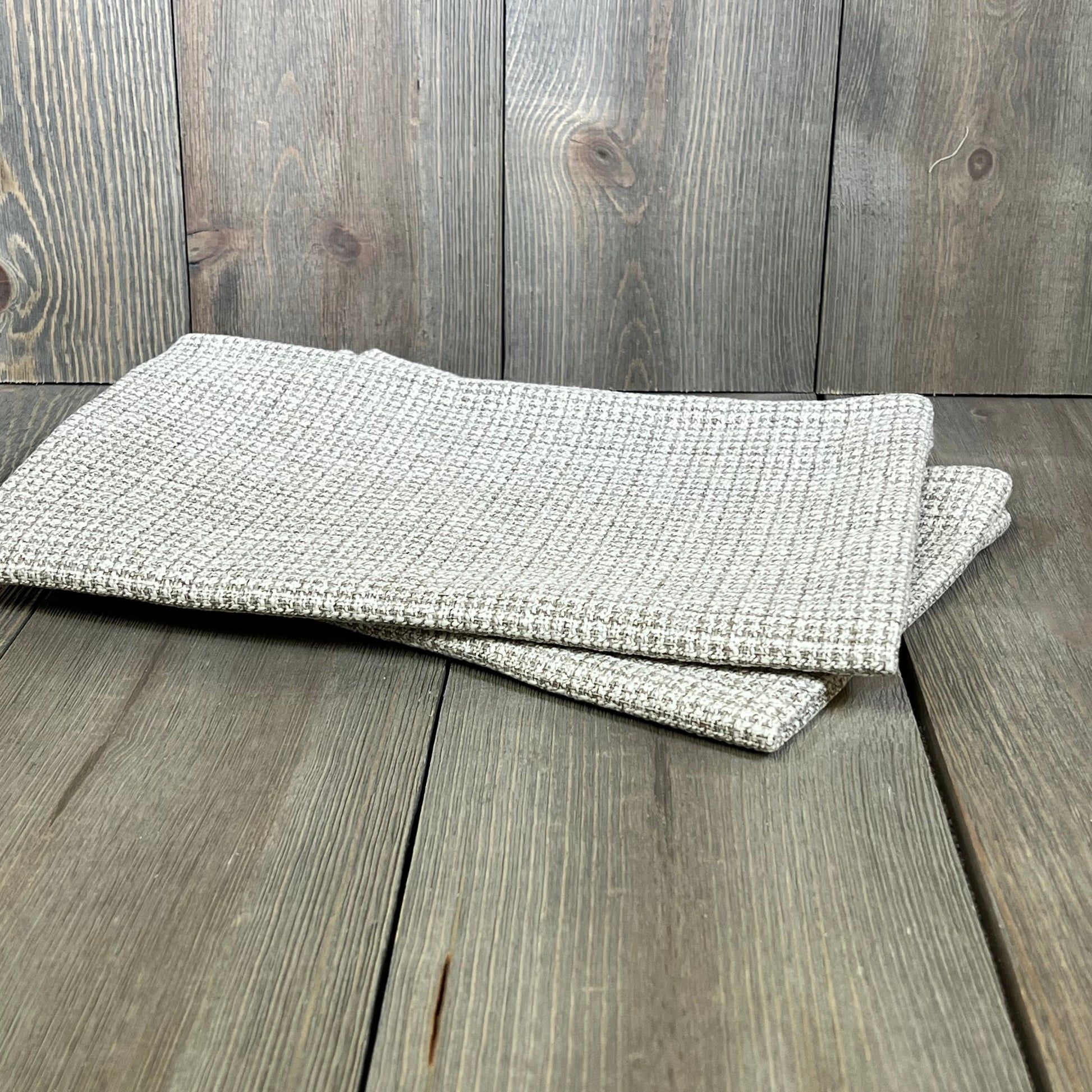 Khaki linen outdoor pillow covers on wooden surface, perfect for patio decor. Waterproof and decorative for couches and sofas.