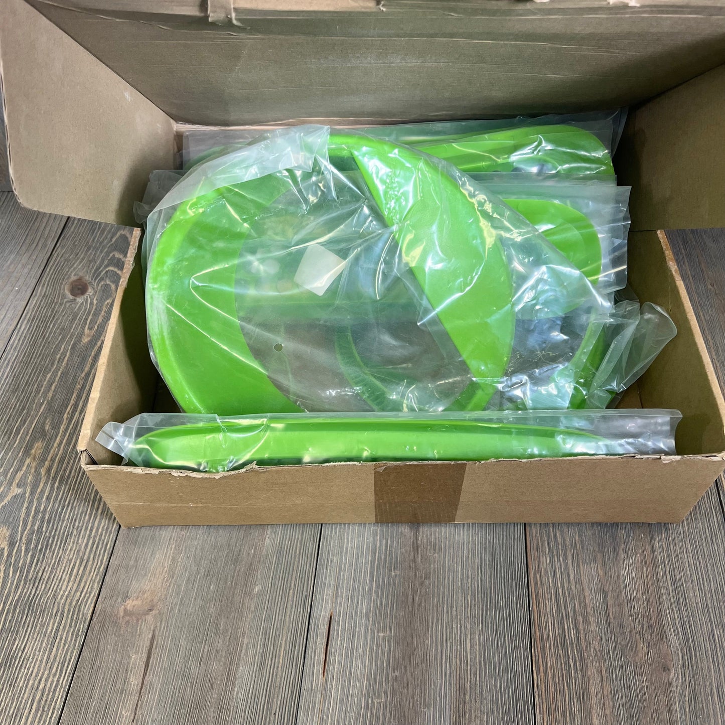 Matte green Jeep Wrangler grille mesh inserts and headlight covers in packaging, ideal for 2007-2017 JK JKU models.