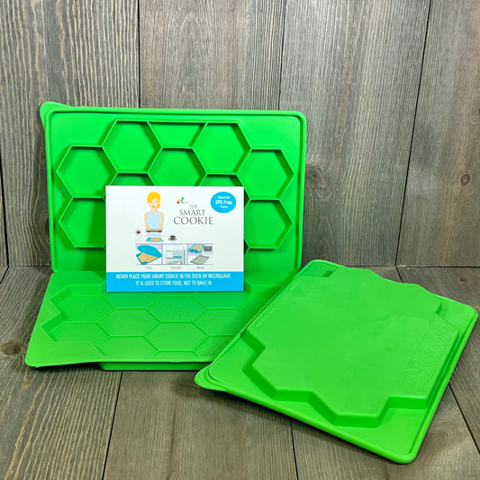 Green Smart Cookie Tray set of 2, featuring hexagonal design for efficient food storage, displayed on a wooden surface.