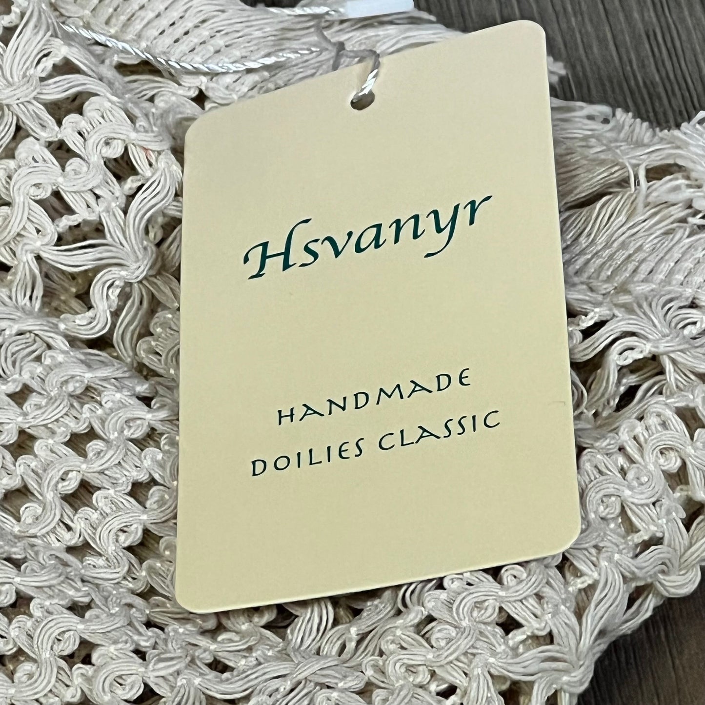 Cream beige macrame table mat with tassel, featuring Hsvanyr tag, handmade cotton linen for farmhouse dining decor.