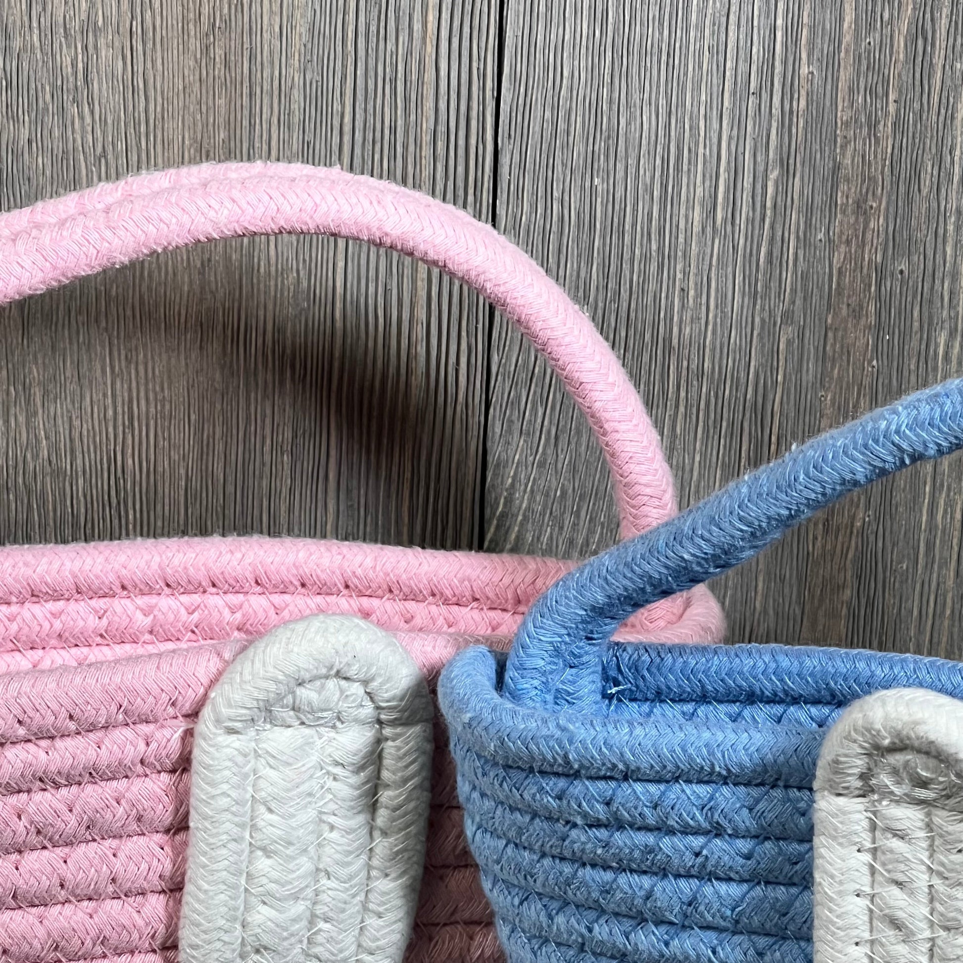 Pink and blue Easter baskets with bunny ears, perfect for toddlers and kids' Easter egg hunts.