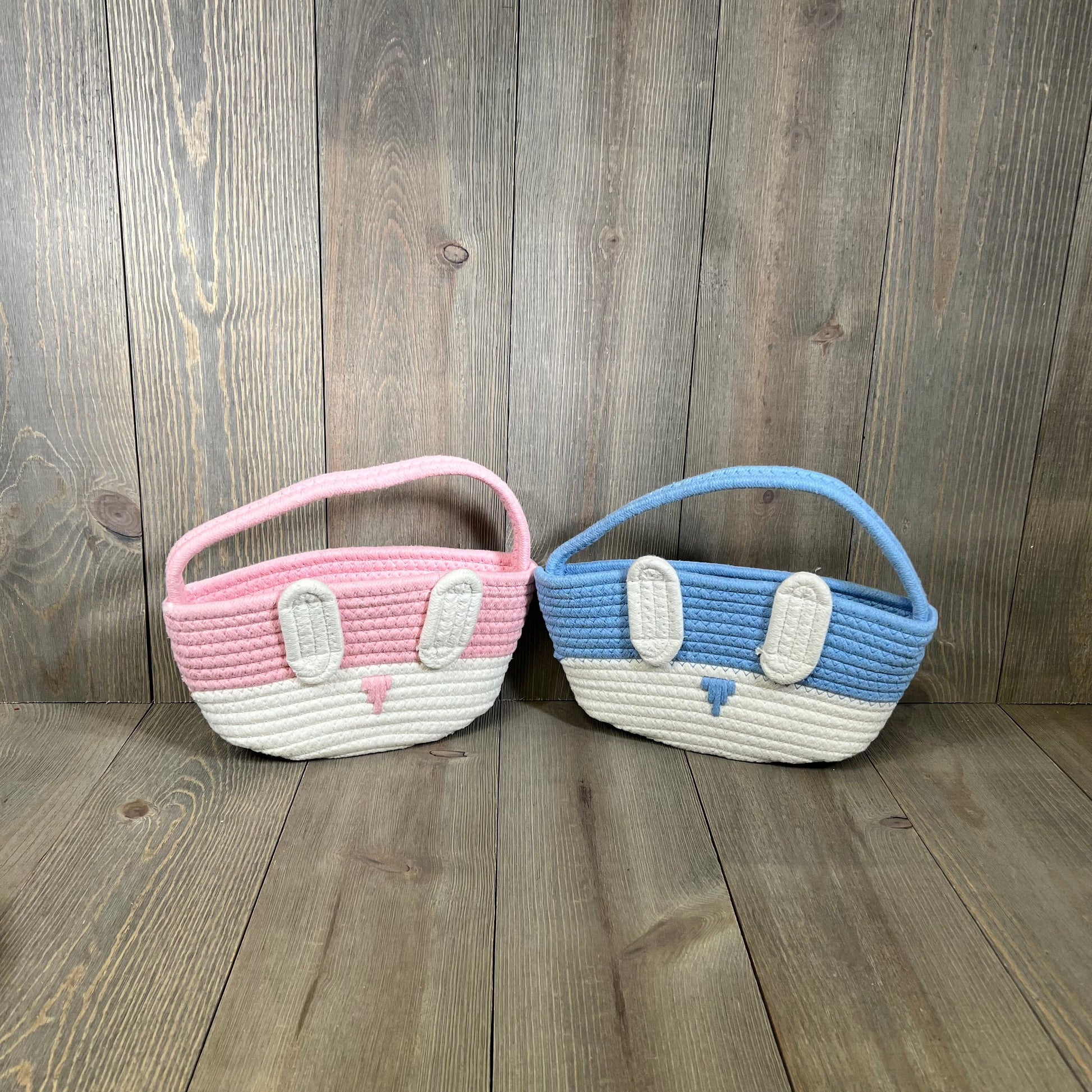 Pink and blue bunny-themed Easter baskets for kids, perfect for egg hunts and gifts, on a wooden background.