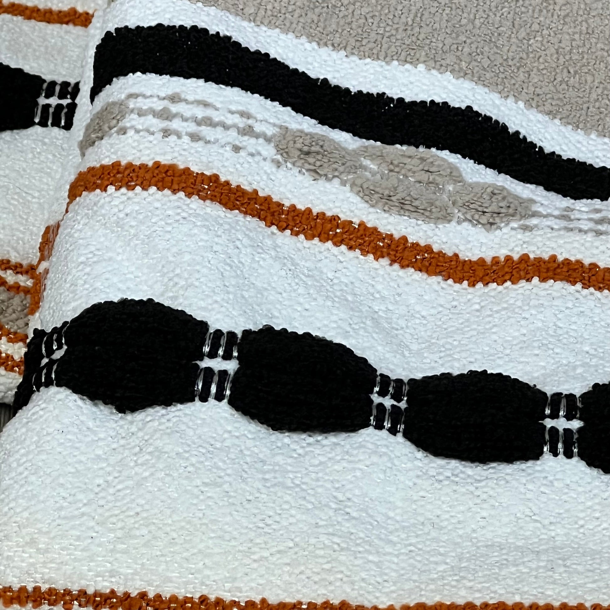 Boho pillow covers with black, orange, and beige stripes, adding a cozy touch to modern farmhouse decor.