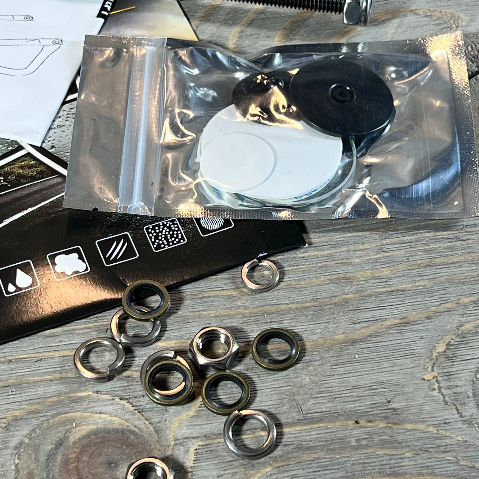 Hardware components for Anti-Shake Door Off Mirrors for Jeep Wrangler on a wooden table.