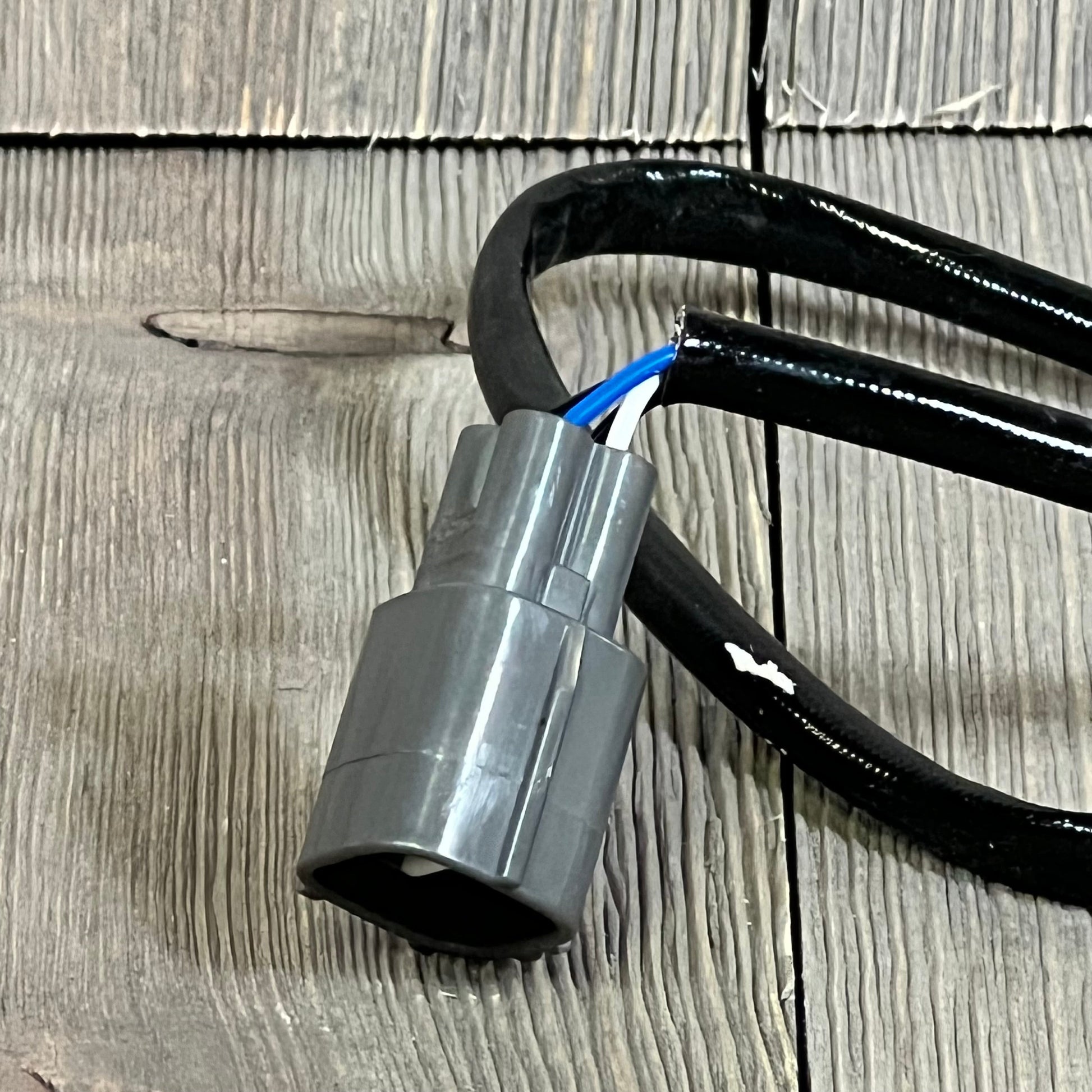 Close-up of 1047104268-BDFHYK Oxygen Sensor plug, compatible with Lexus and Toyota models, showing connector detail.