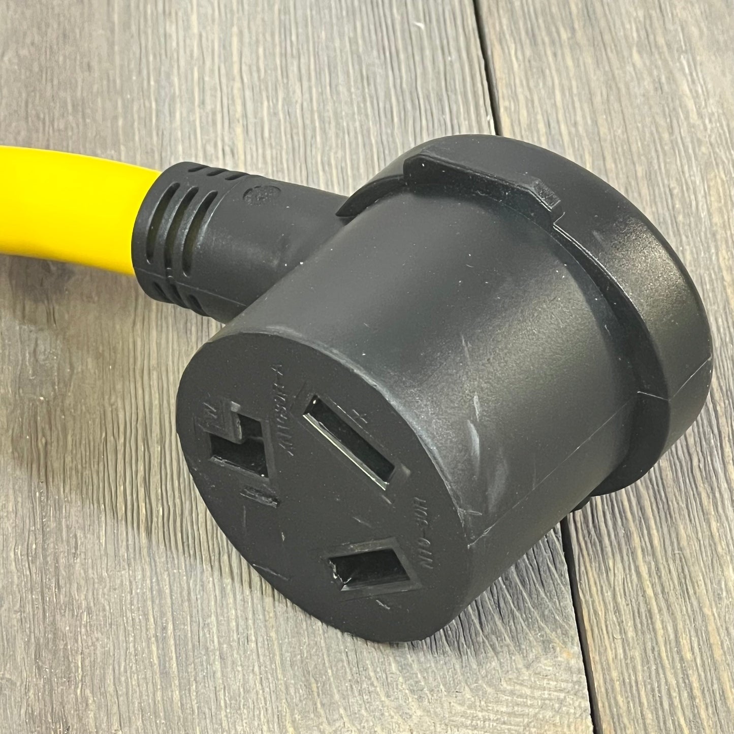 Black 15 Amp Kanayu adapter with 3-prong female receptacle for 120V devices, featuring durable construction.