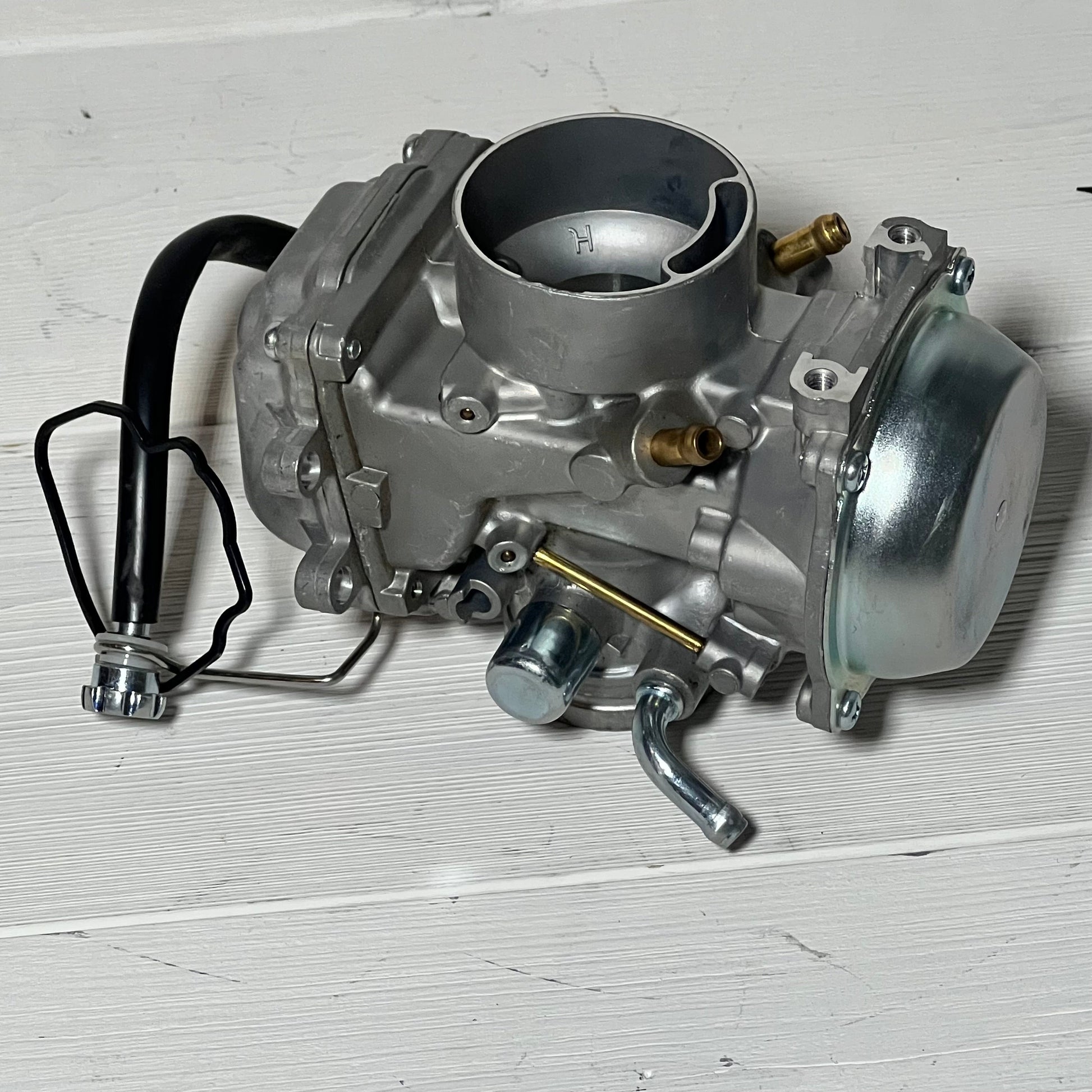 High-quality side view of Caltric Carburetor for Suzuki LT-F250 Quadrunner 250 2X4 1990-1993 on a white background.