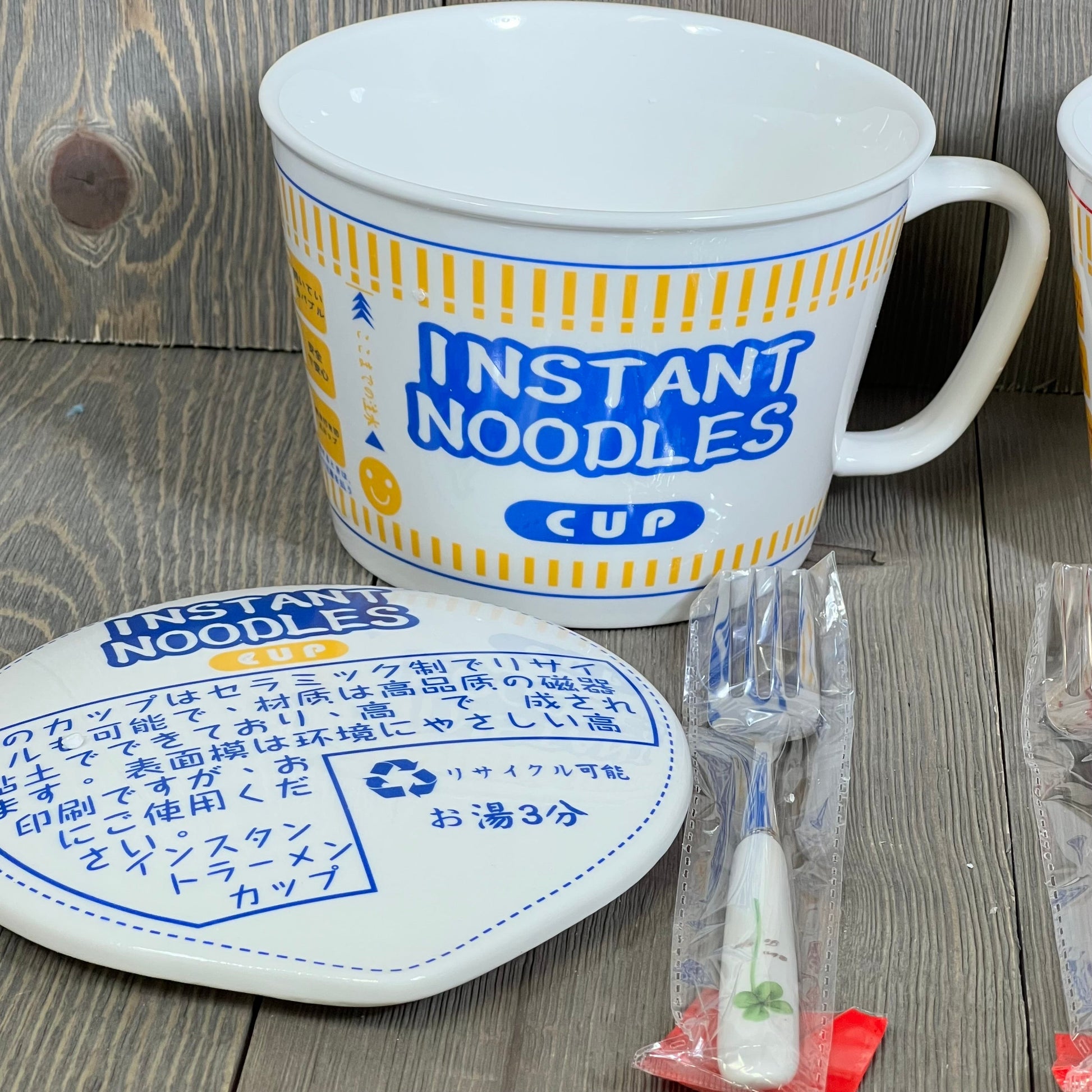 Anime-inspired ceramic ramen bowl with lid and handle, featuring "Instant Noodles" design, includes a fork. Perfect for noodle lovers.