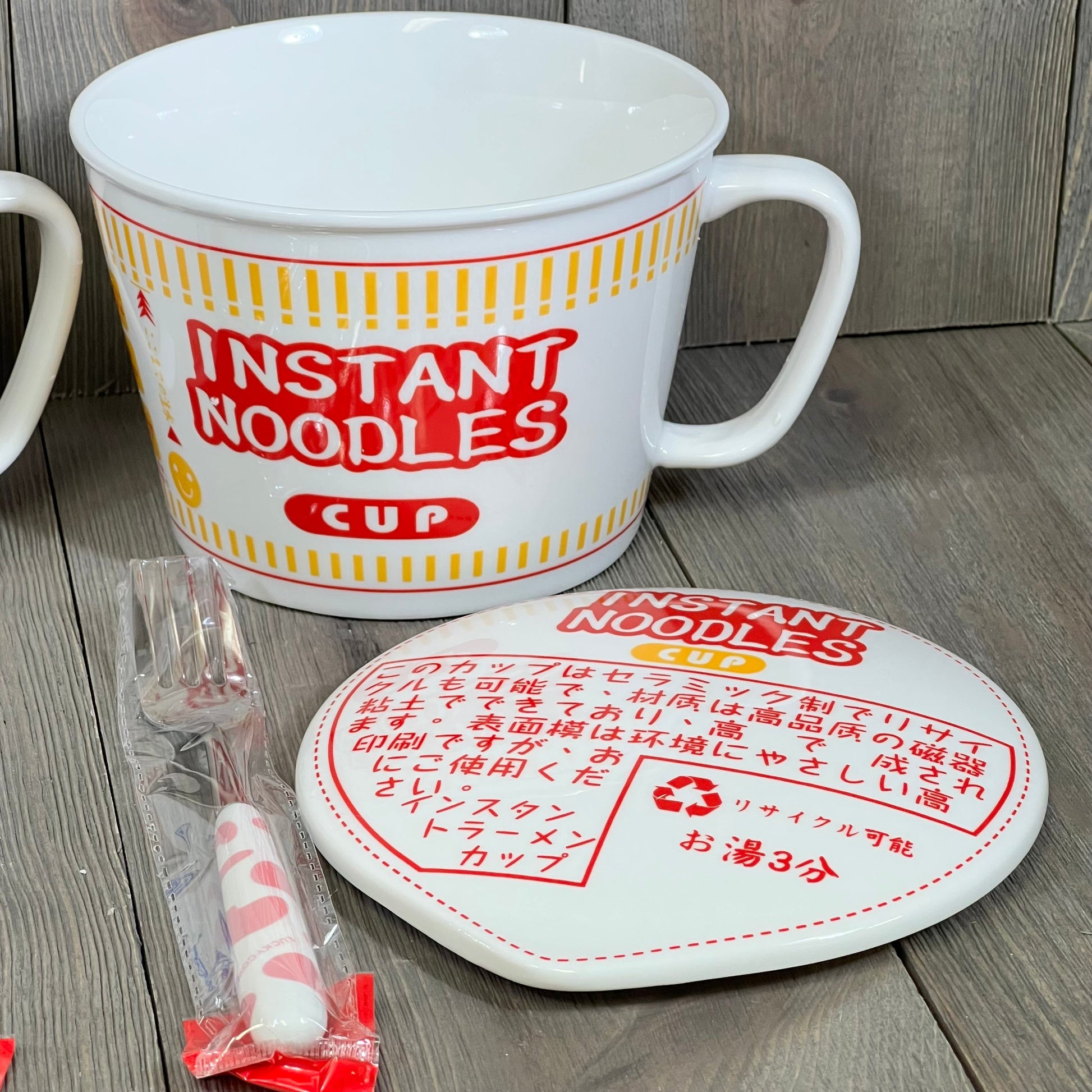 Anime-themed ceramic ramen bowl with lid and handle, featuring vibrant red and yellow design, perfect for noodle lovers.
