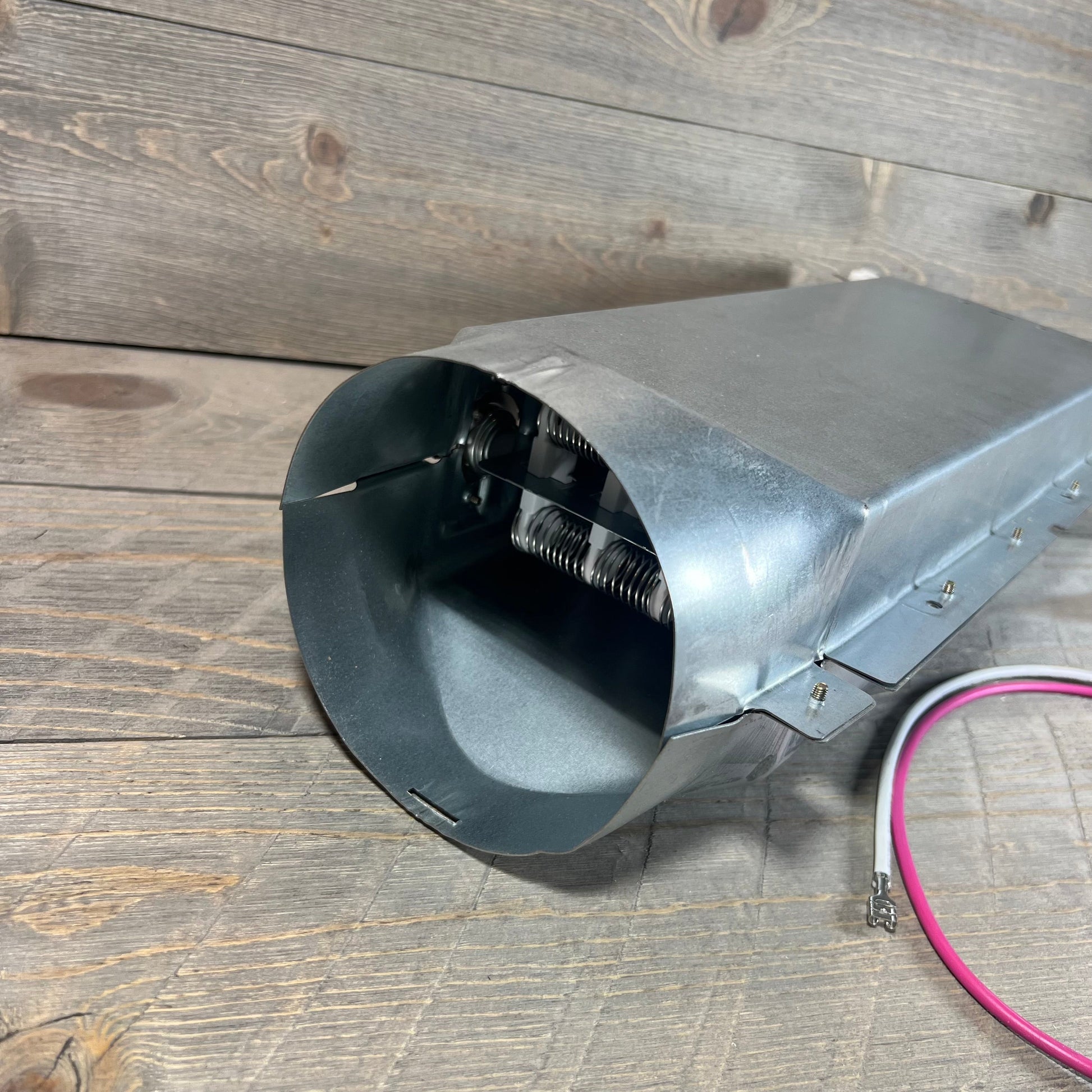 LG dryer heating element assembly, BlueStars 5301EL1001A, shown on a wooden surface with visible wiring.