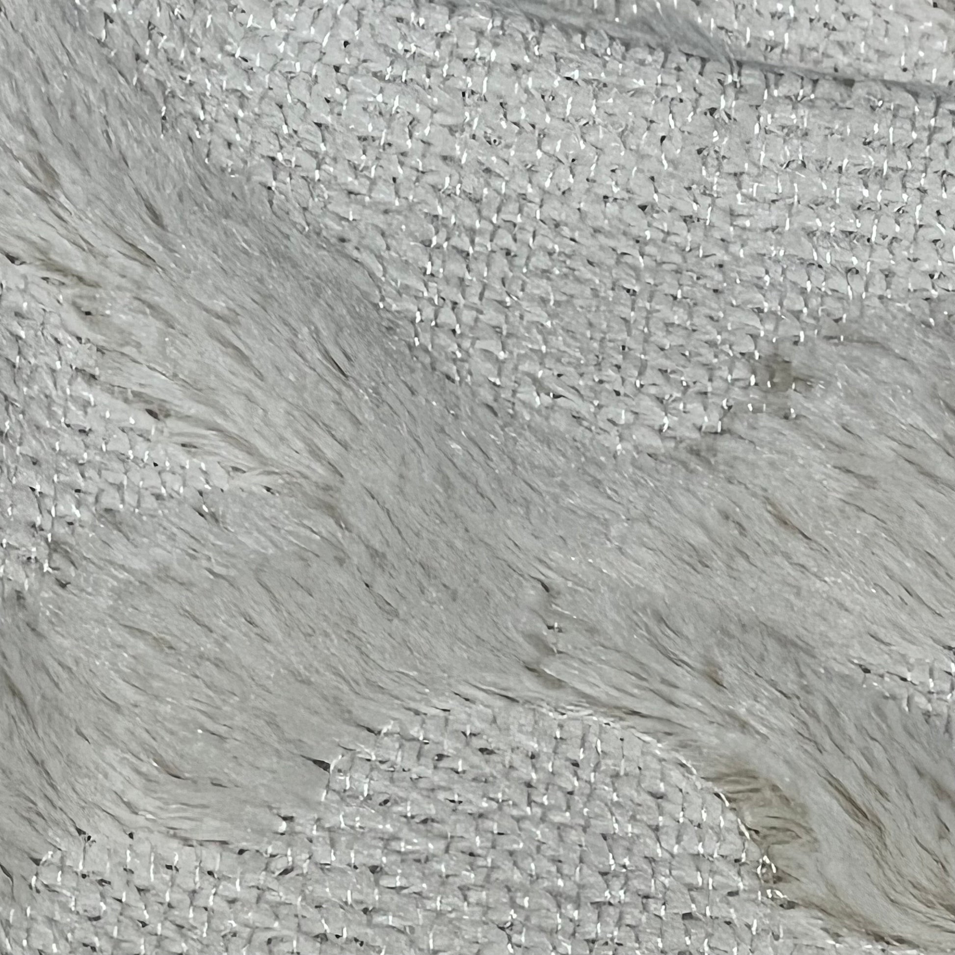 Close-up of beige Moroccan boho pillow cover texture, showcasing soft plush fabric and intricate stitching details.