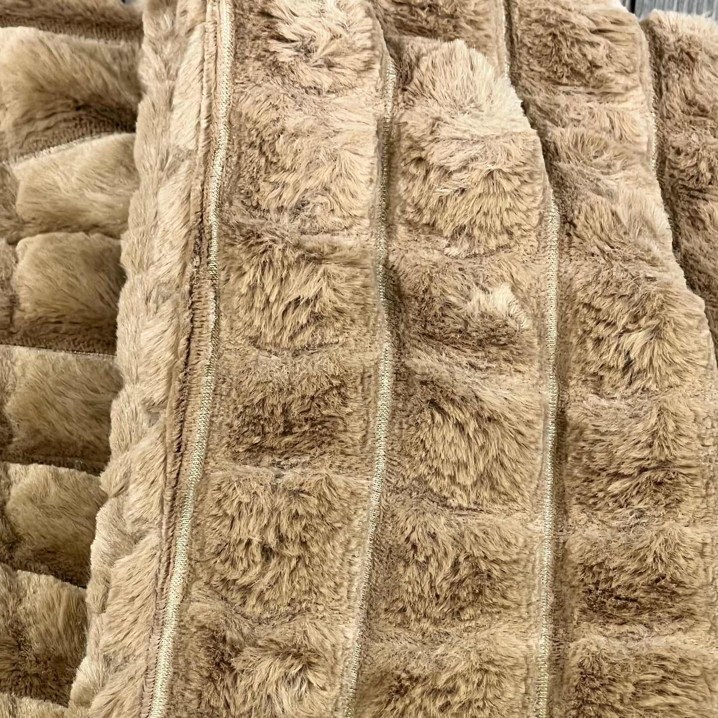 Luxurious brown faux fur pillow covers with plaid texture, perfect for modern home decor on sofas and beds.