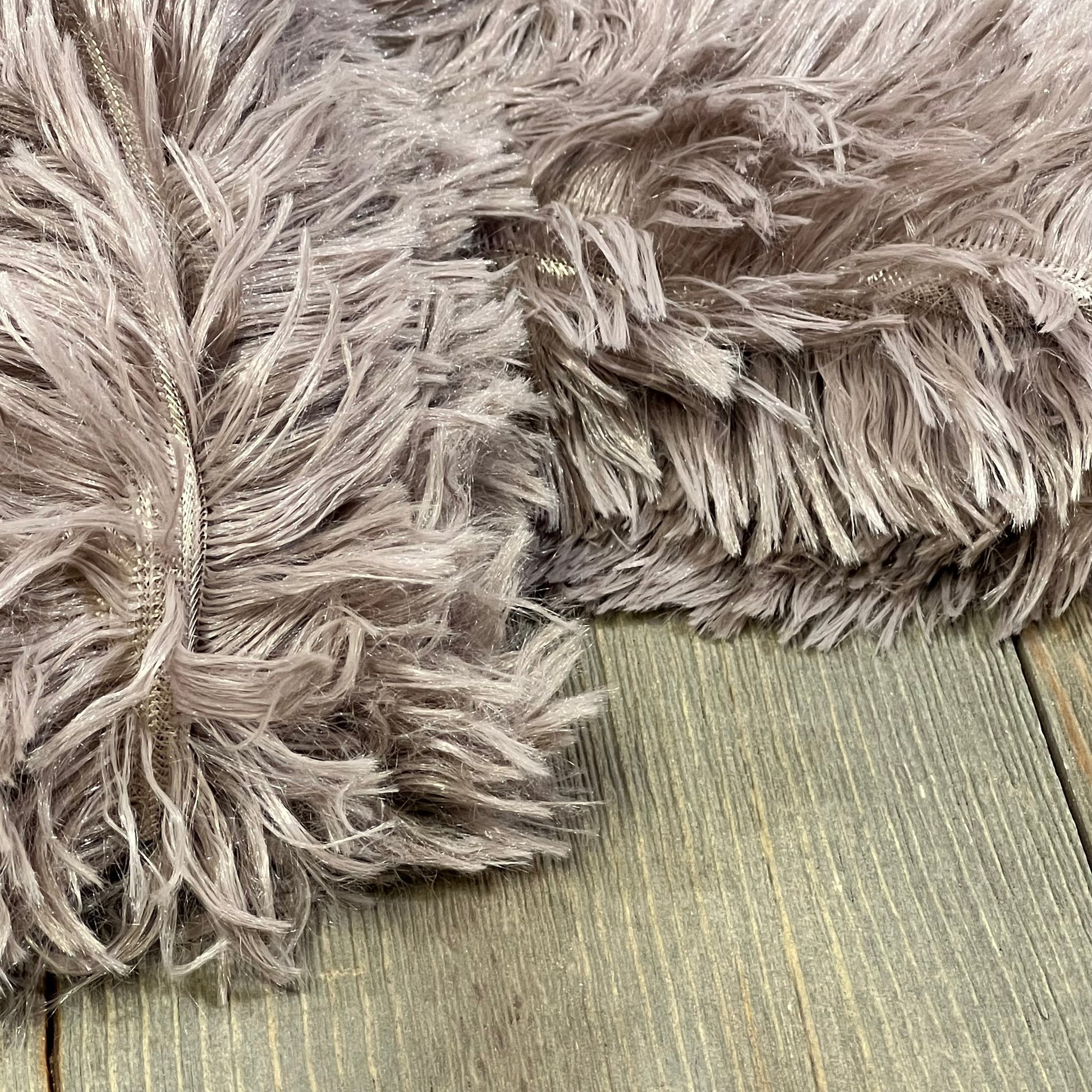 Purplish taupe faux fur pillow covers with soft velvet texture on wooden surface, showcasing zipper detail, 20"x36".
