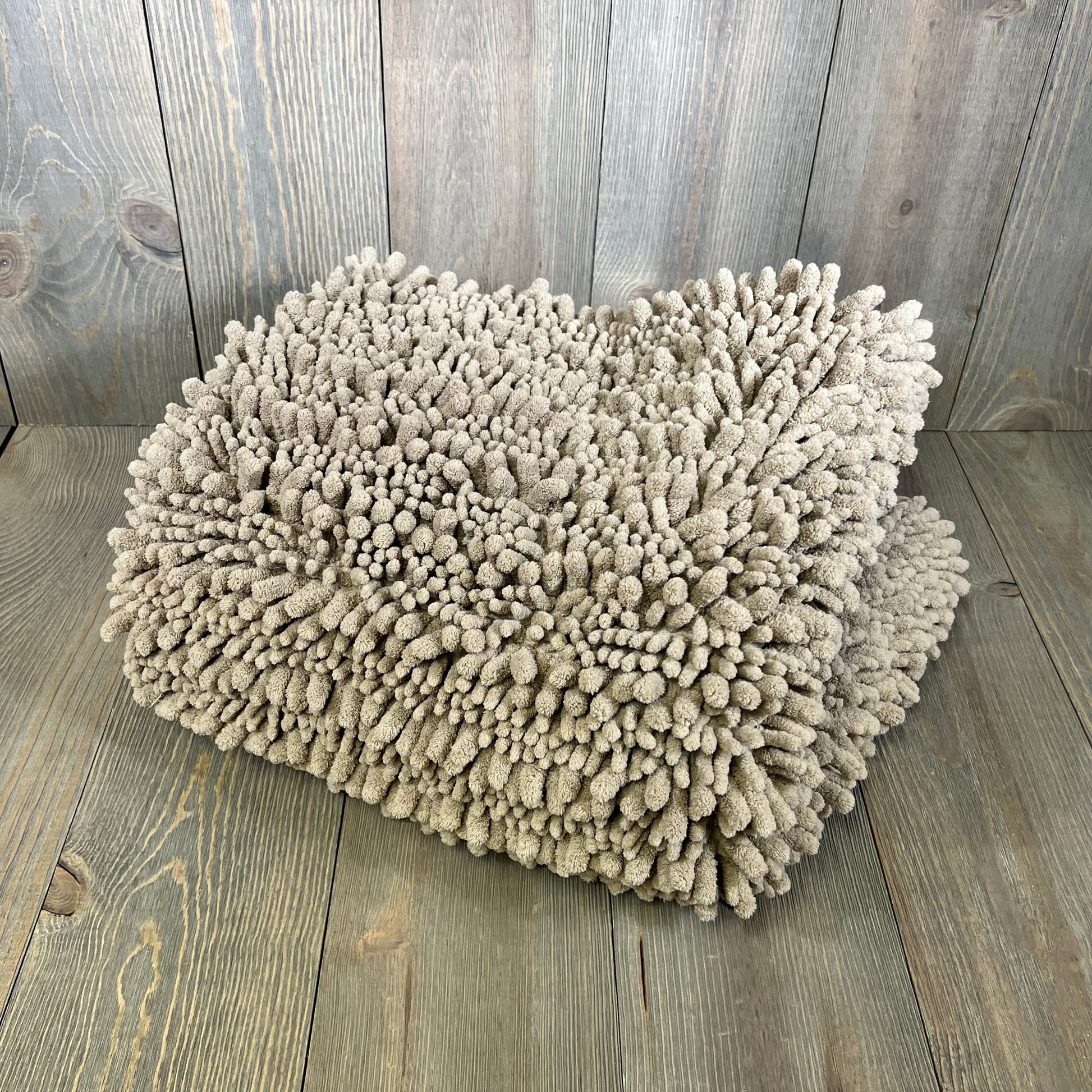 Large Yimobra bath mat in pale khaki chenille, showcasing its thick, absorbent, shaggy texture on wooden floor.