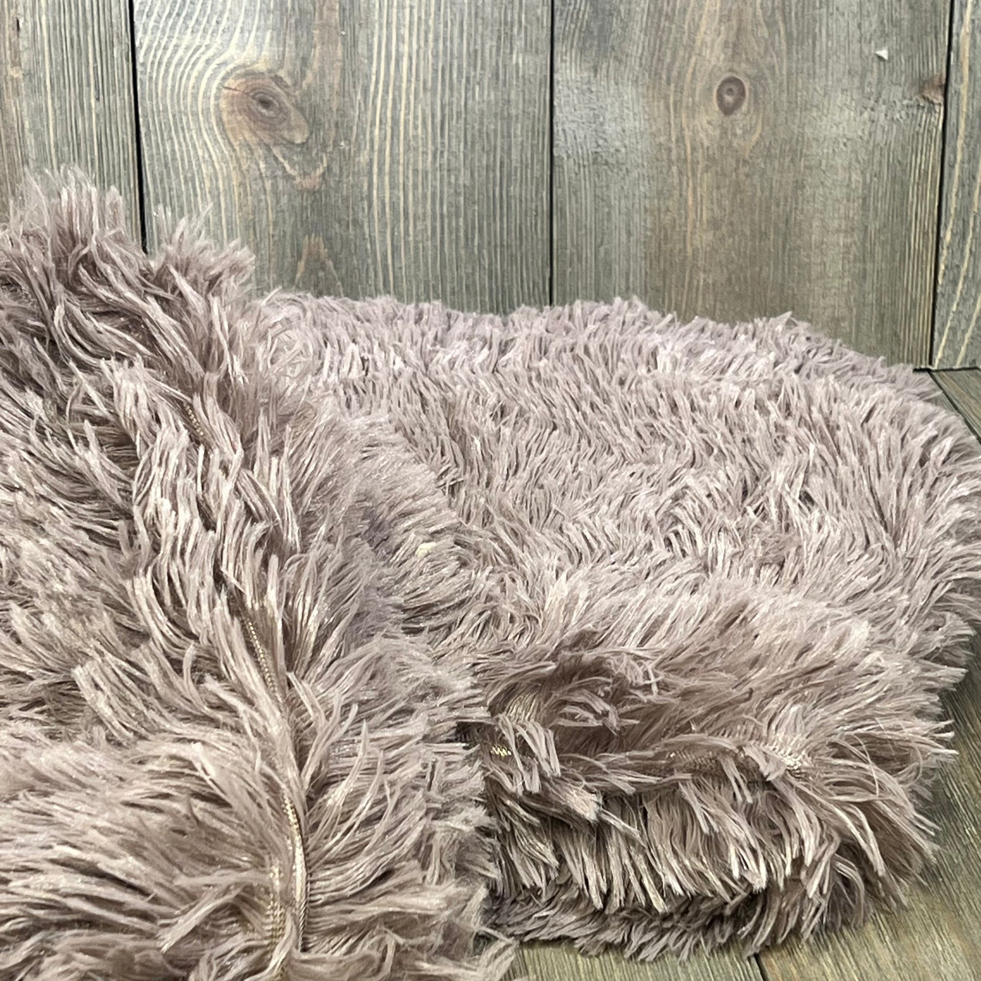 Purplish taupe faux fur pillow covers with soft velvet texture and zipper closure, adding cozy elegance to any decor.