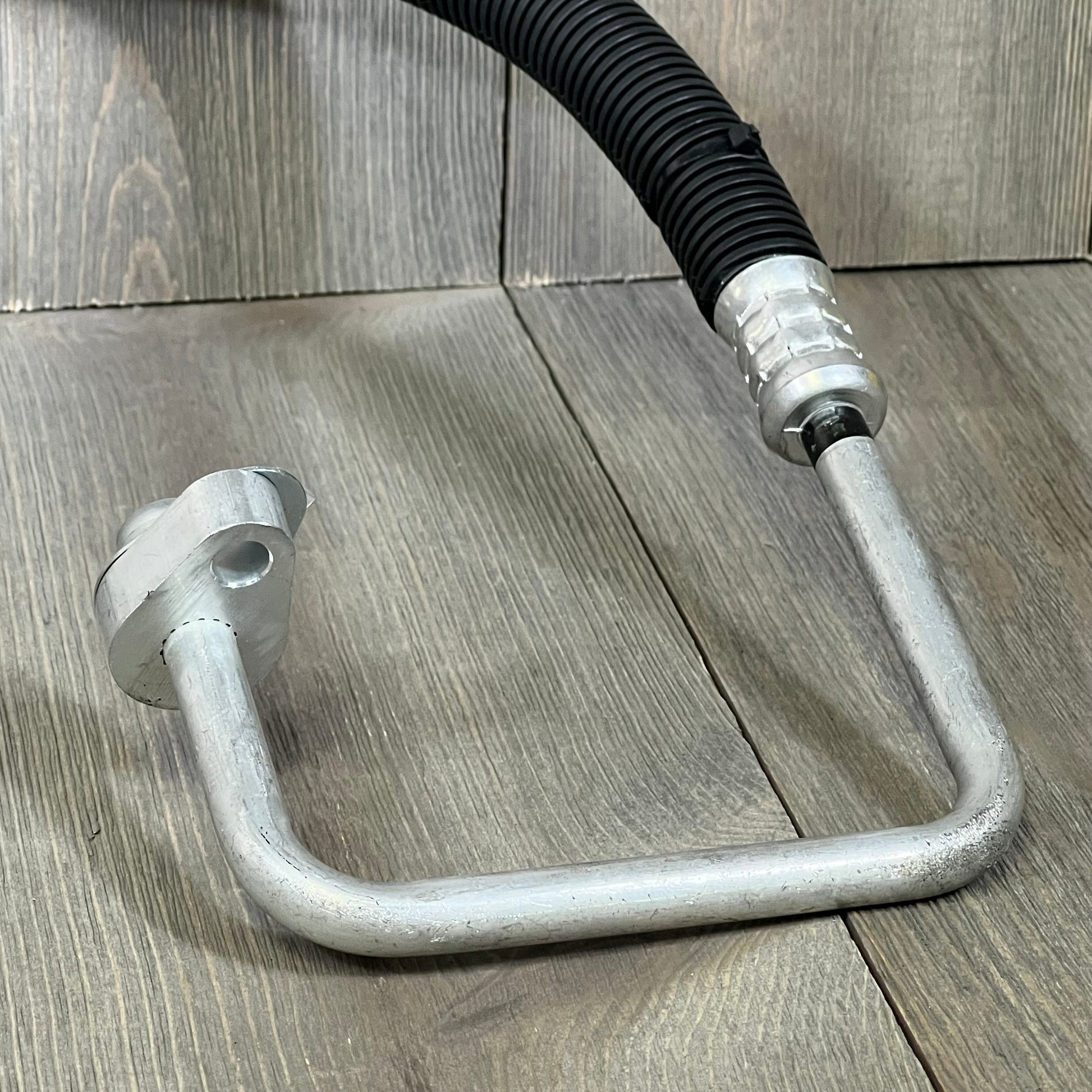 A-Premium A/C discharge line hose assembly for Ford Explorer 2013-2019, showcasing durable metal construction and fittings.