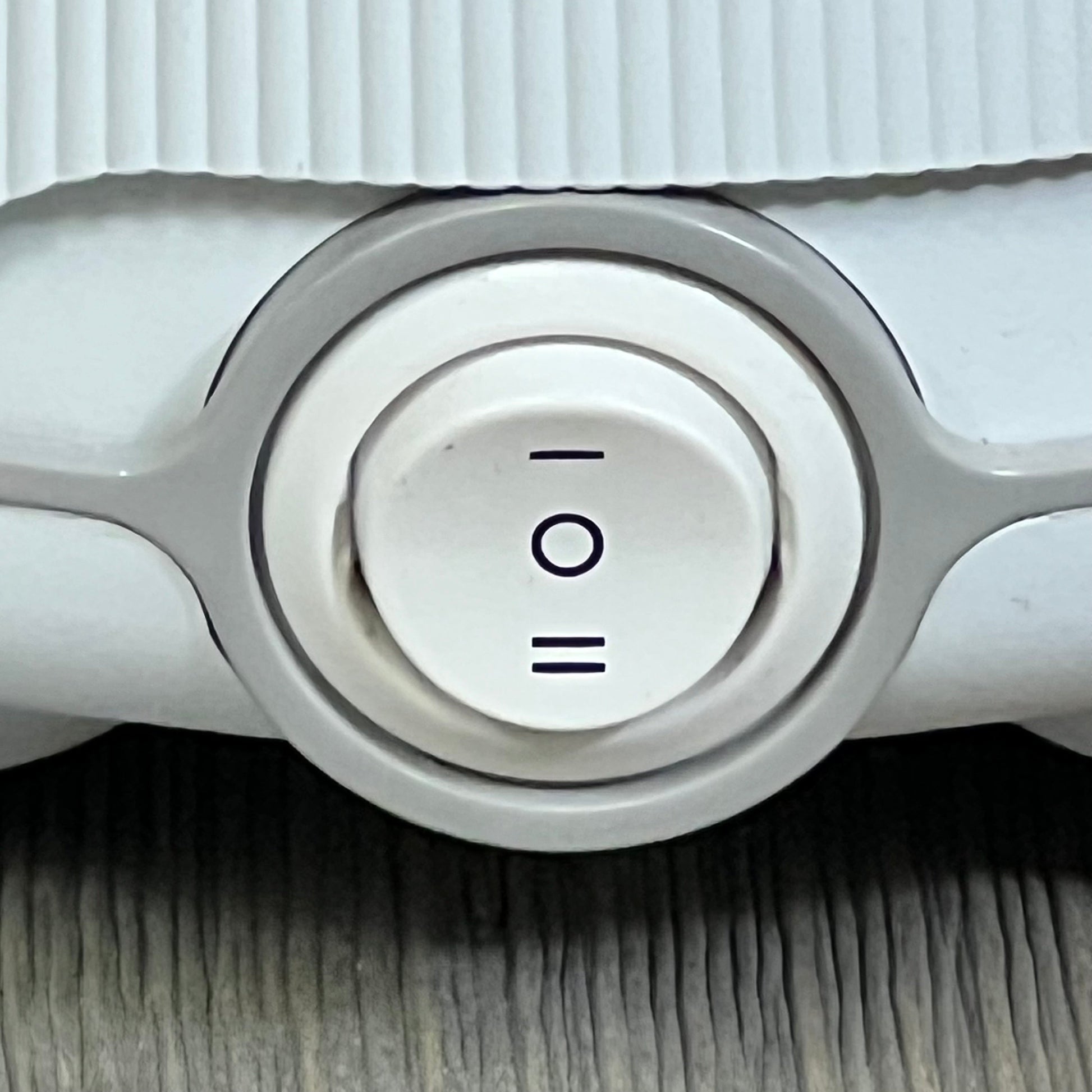 White and gray Yogasleep Dohm white noise machine close-up, featuring adjustable fan settings for personalized sound.
