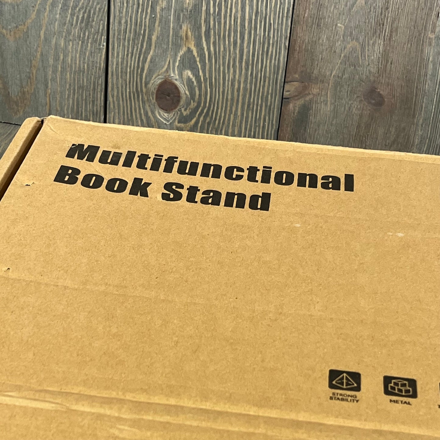 Cardboard packaging of the YCNEW Desk Clamp Acrylic Book Stand, showcasing its multifunctional design and sturdy build.