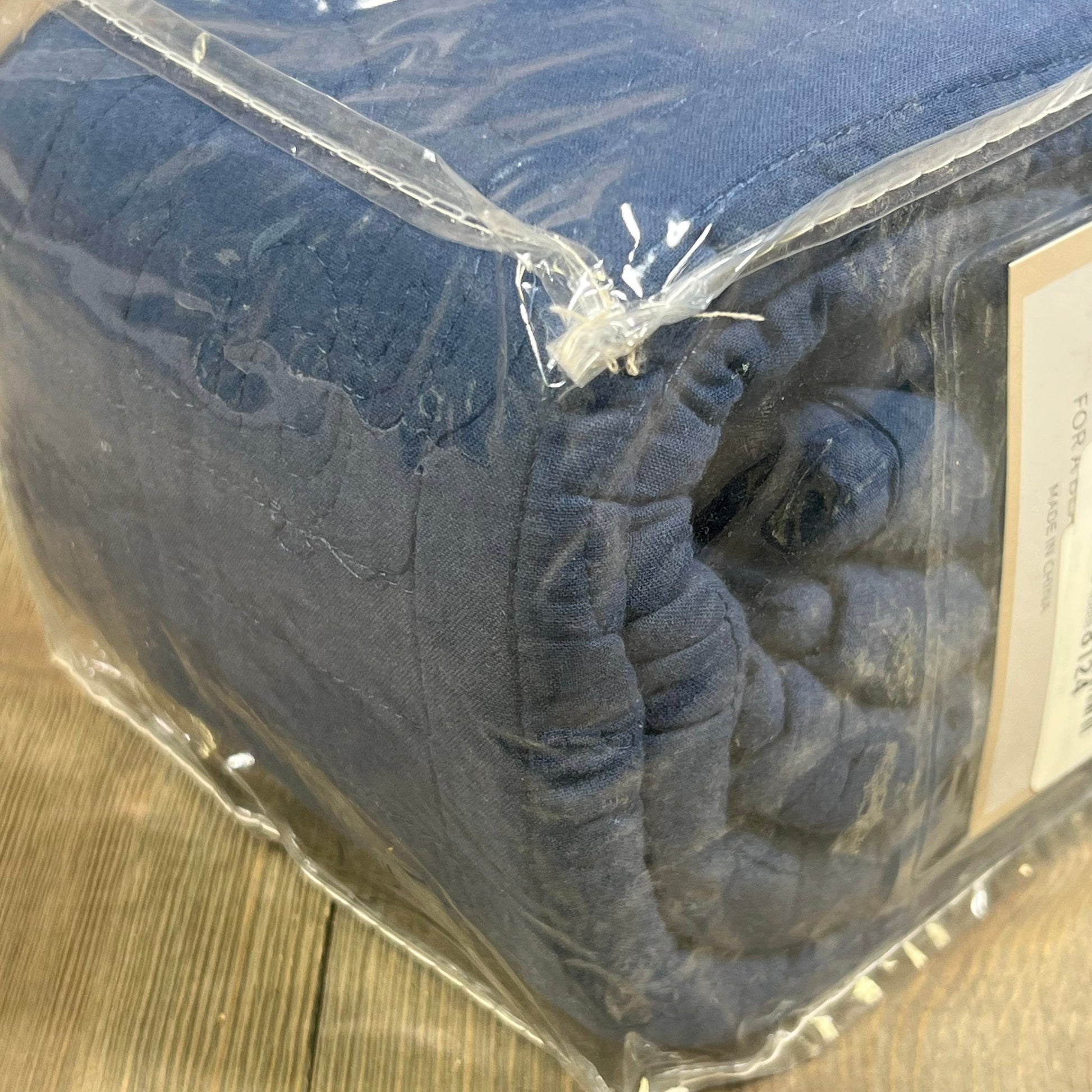 Navy blue quilted pillow sham in packaging, showcasing 100% cotton floral design for king-size comfort and elegance.