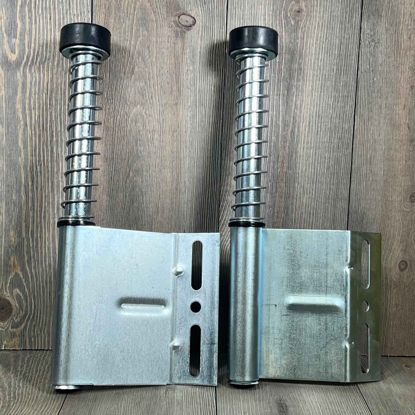 Pair of 15" garage door plunger bumpers with springs for opener systems, left and right parts, durable metal design.