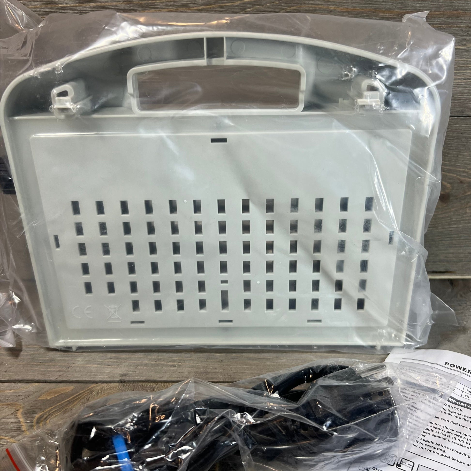 Power supply replacement for Dolphin Diagnostic models in packaging on wooden surface.