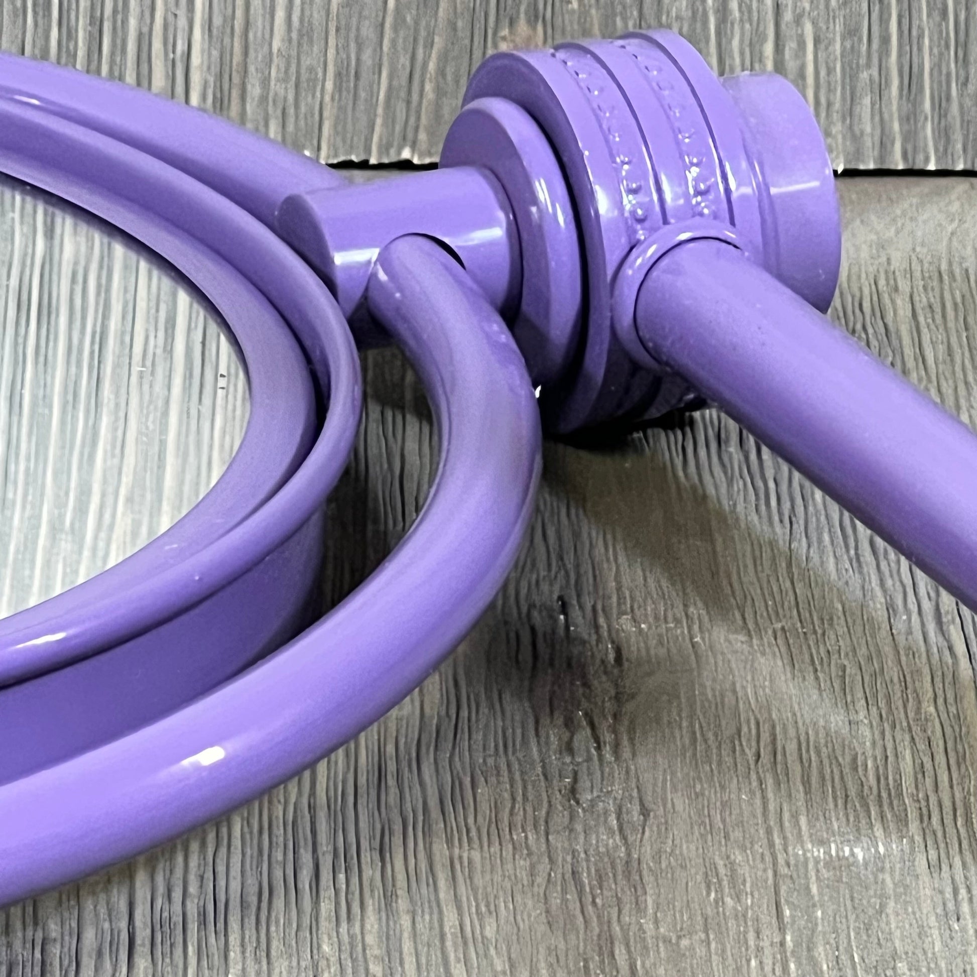 Lavender wall-mounted mirror with twist accent, showcasing extendable arm for Allied Brass 4X magnification makeup application.