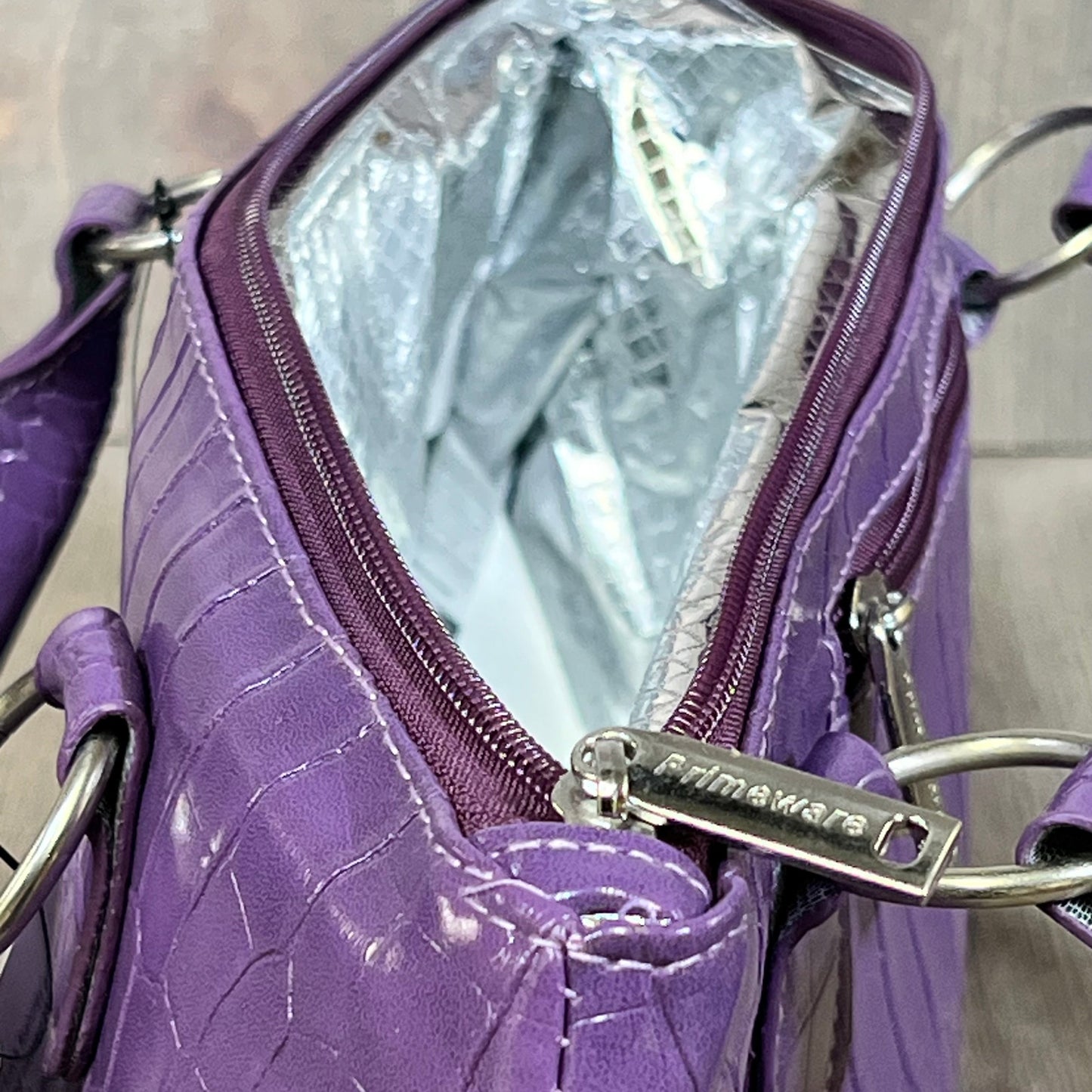 Purple Primeware wine clutch bag showing thermal insulation interior for optimal wine temperature control.