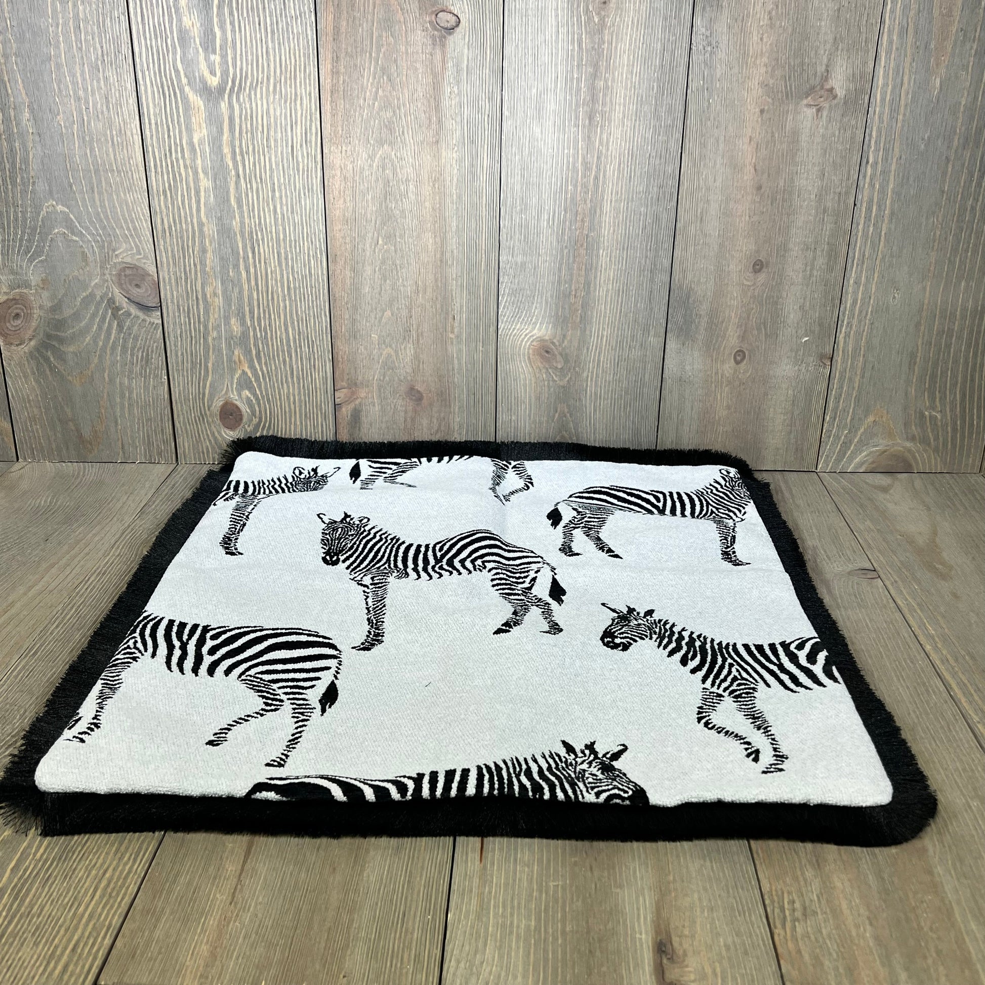 Zebra pattern throw pillow cover with luxury embroidery on wooden background, perfect for modern living rooms and bedrooms.