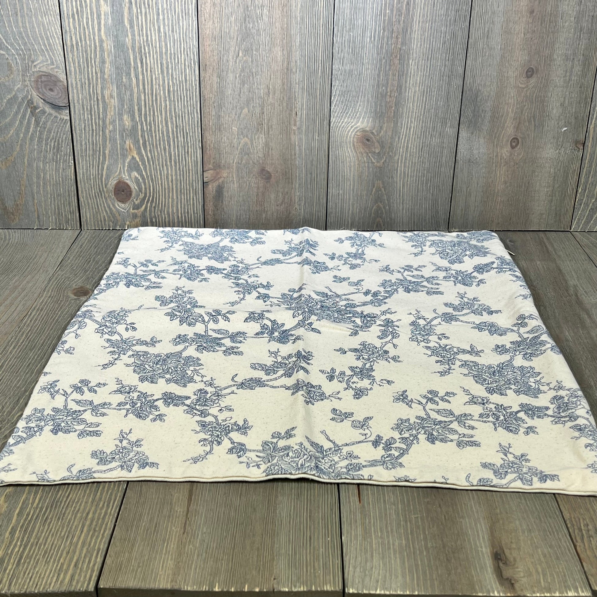 Blue floral French pastoral throw pillow cover on rustic wood background, 16x16 inches, perfect for farmhouse decor.