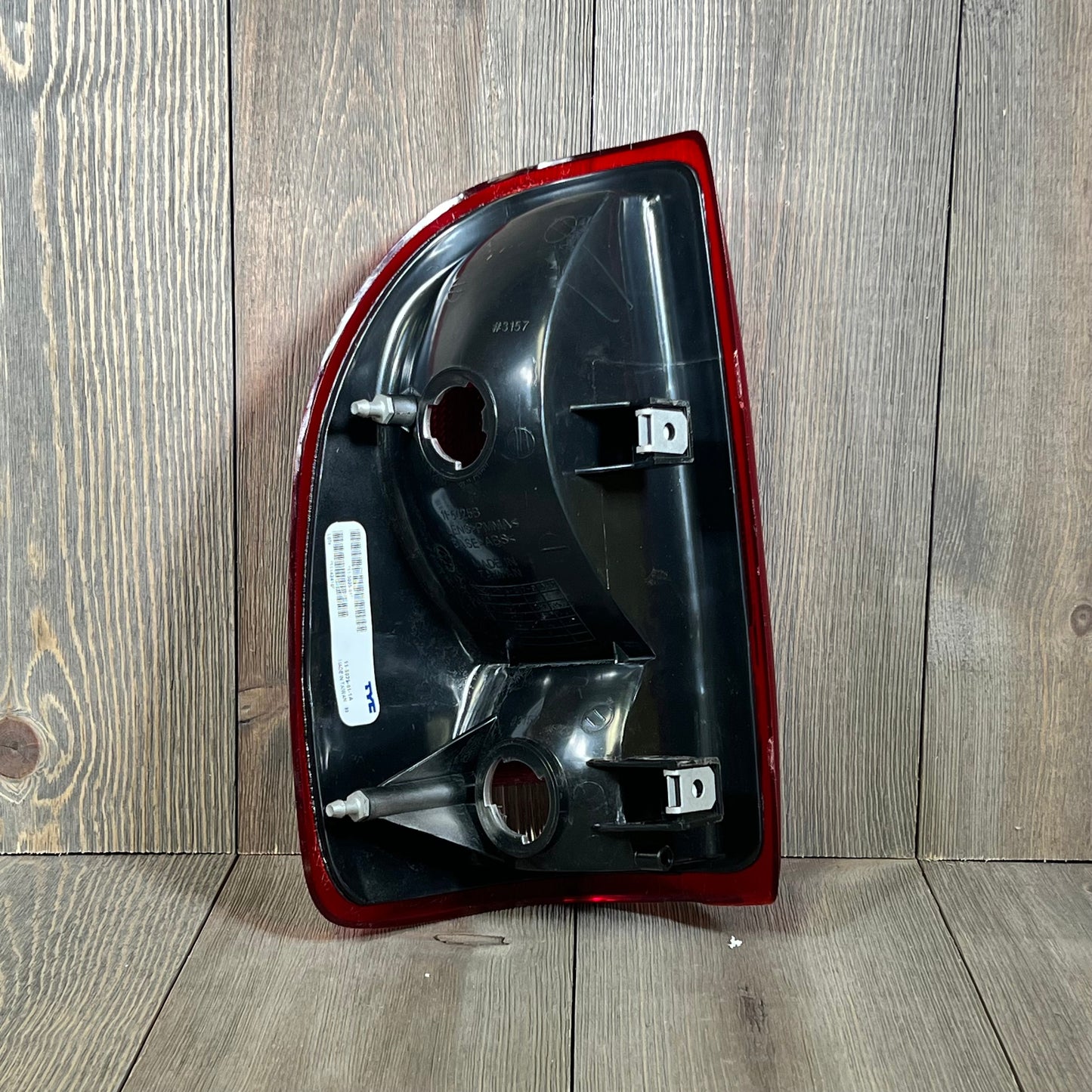 TYC right tail light assembly for 1997-2004 Dodge Dakota, rear view showing mounting points and part details.