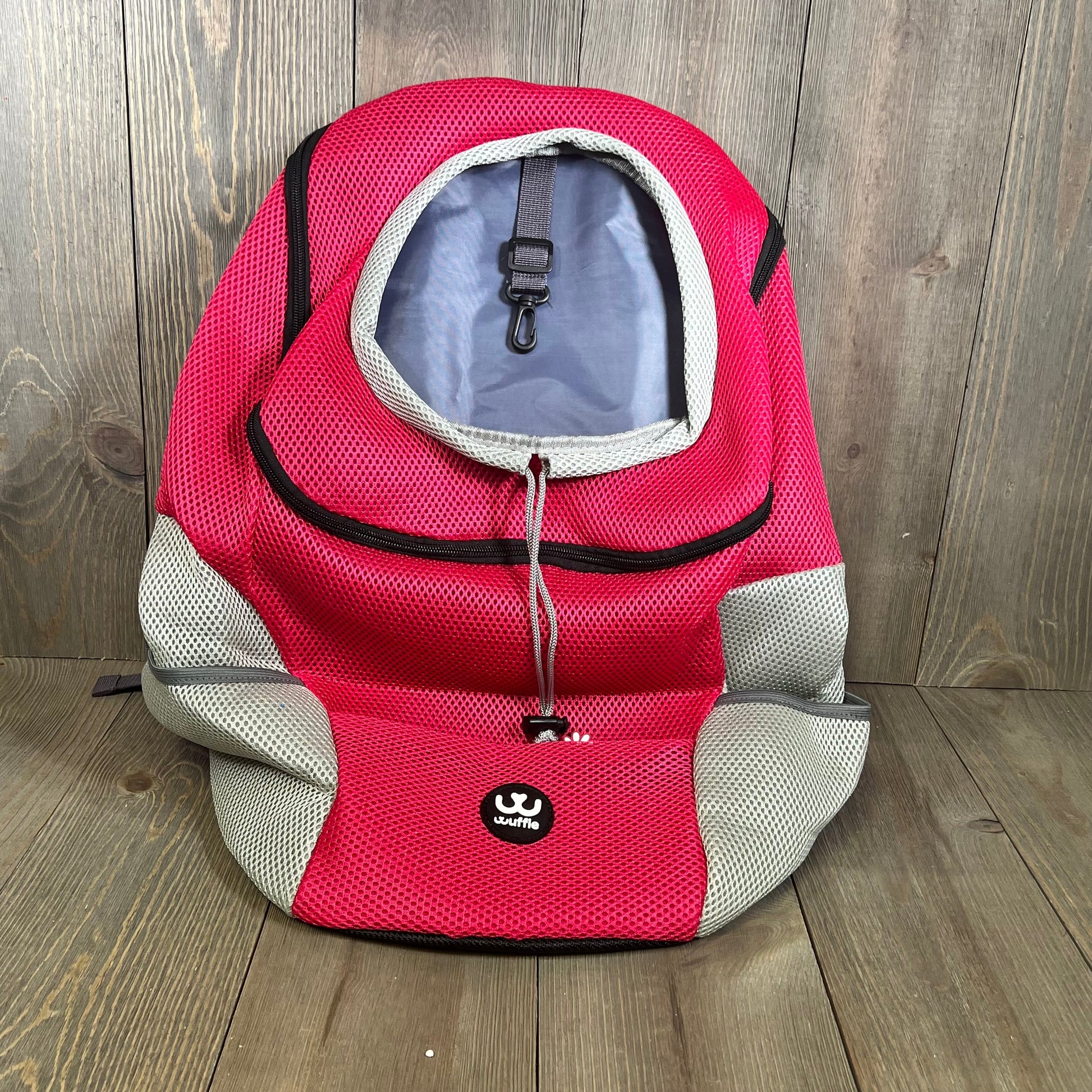 Pink wuffie pet carrier backpack with breathable mesh window and safety belt, perfect for small to large dogs.