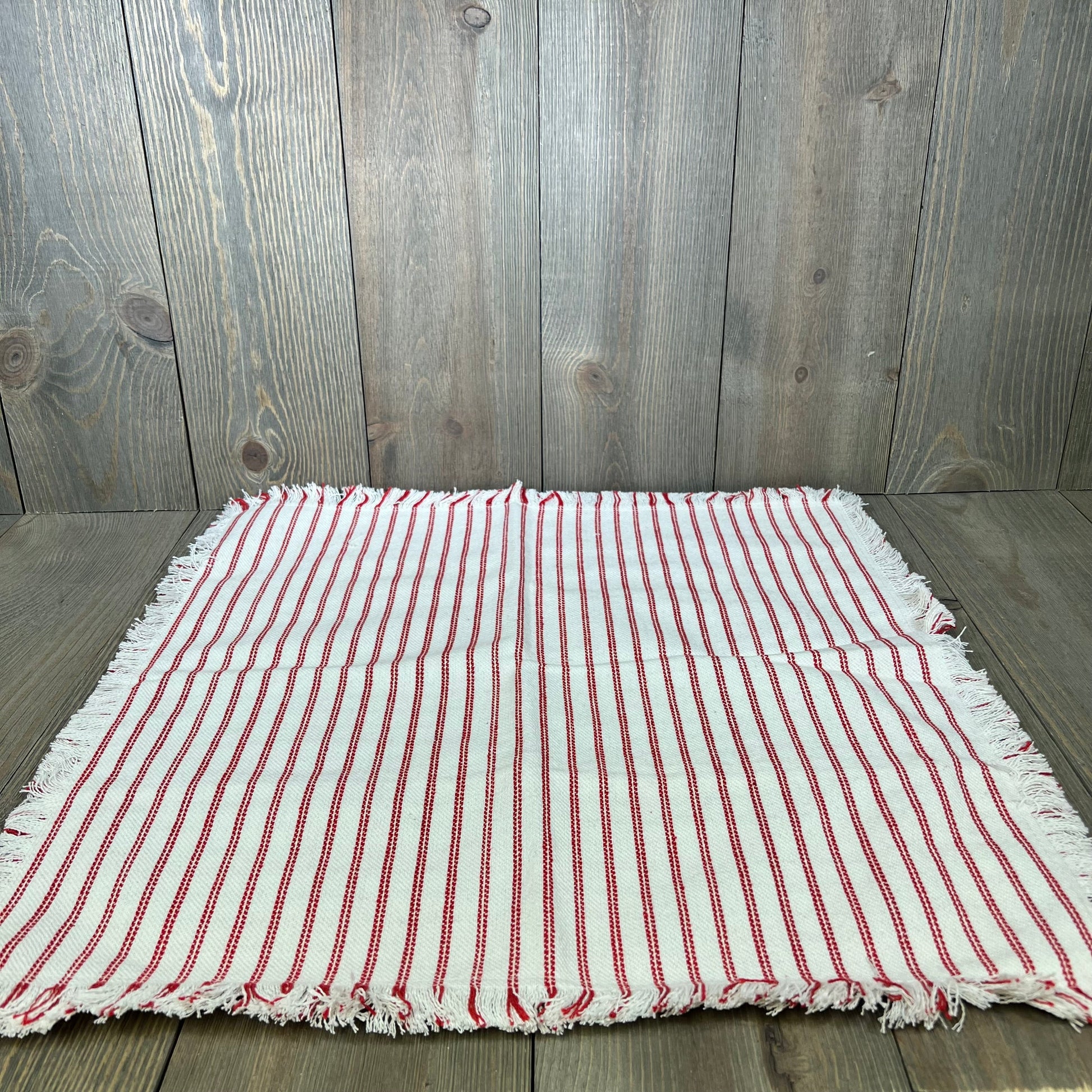 Red striped farmhouse throw pillow cover with fringe tassels, perfect for boho chic decor on sofas or beds.