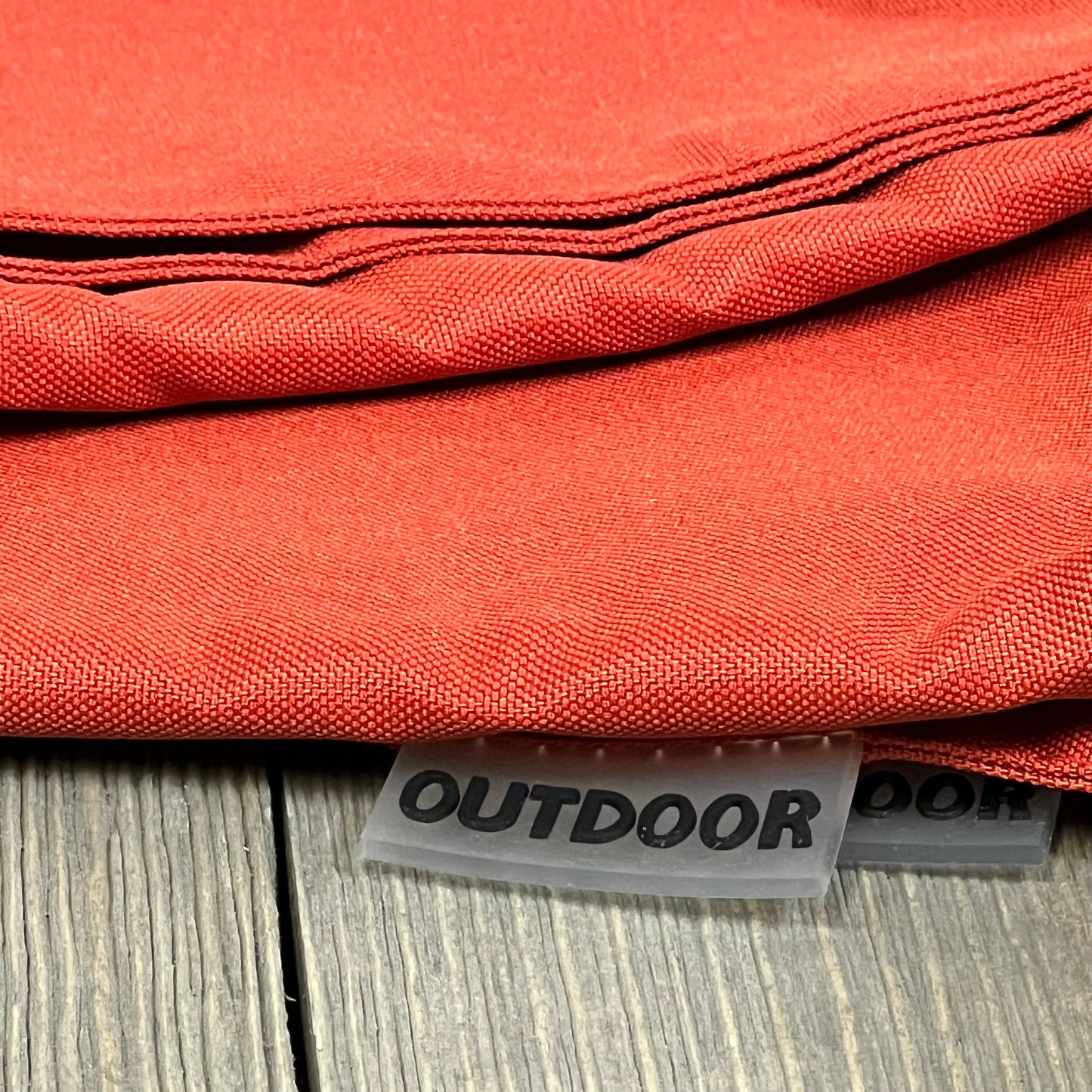 Burnt brick outdoor pillow covers with waterproof fabric, ideal for patio or garden, showcasing durable stitching and texture.